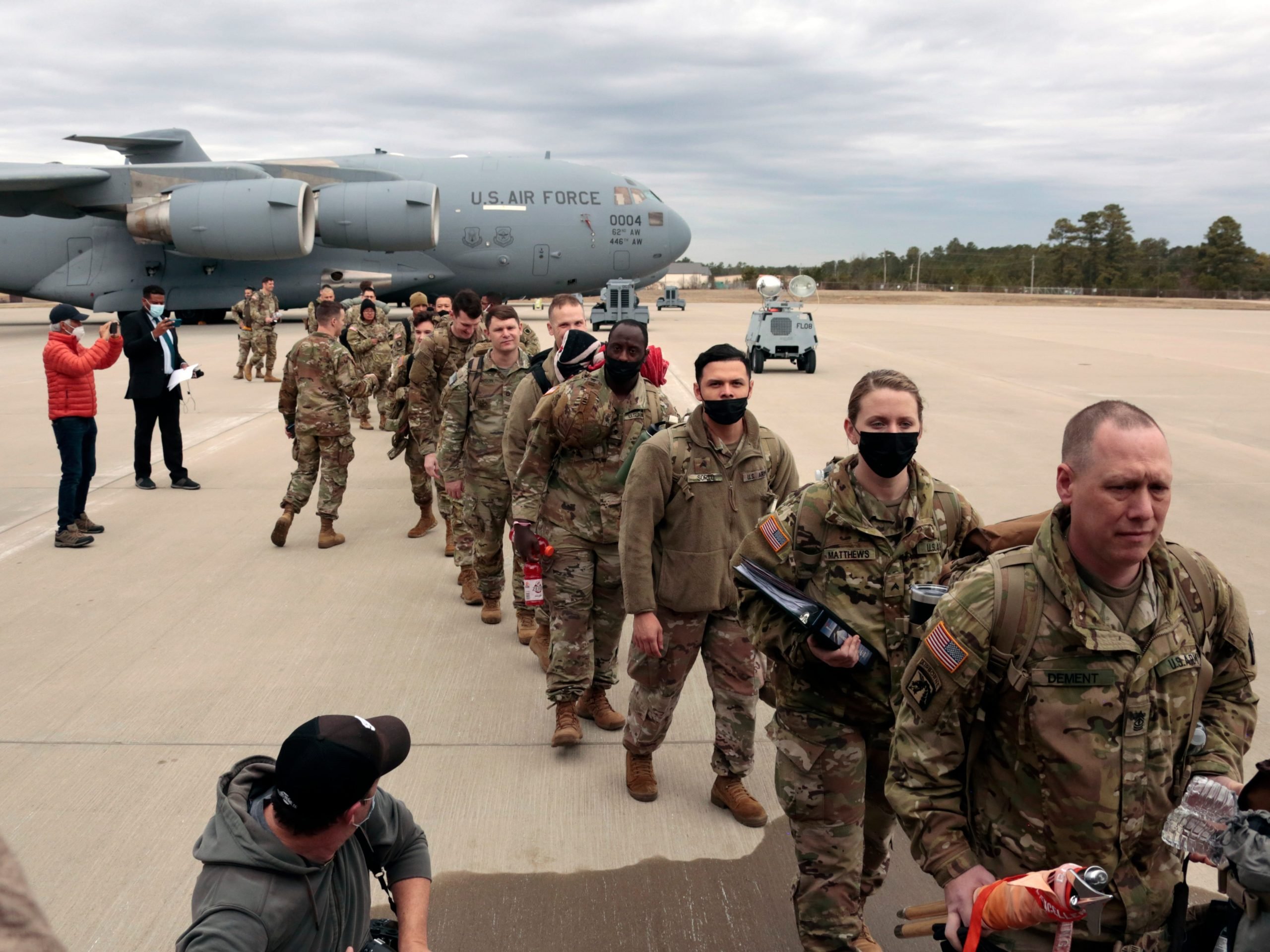 U.S. Army soldiers from the 18th Airborne Division prepare to board a C-17 aircraft as they deploy to Europe from Fort Bragg, N.C., on Thursday, Feb. 3, 2022.