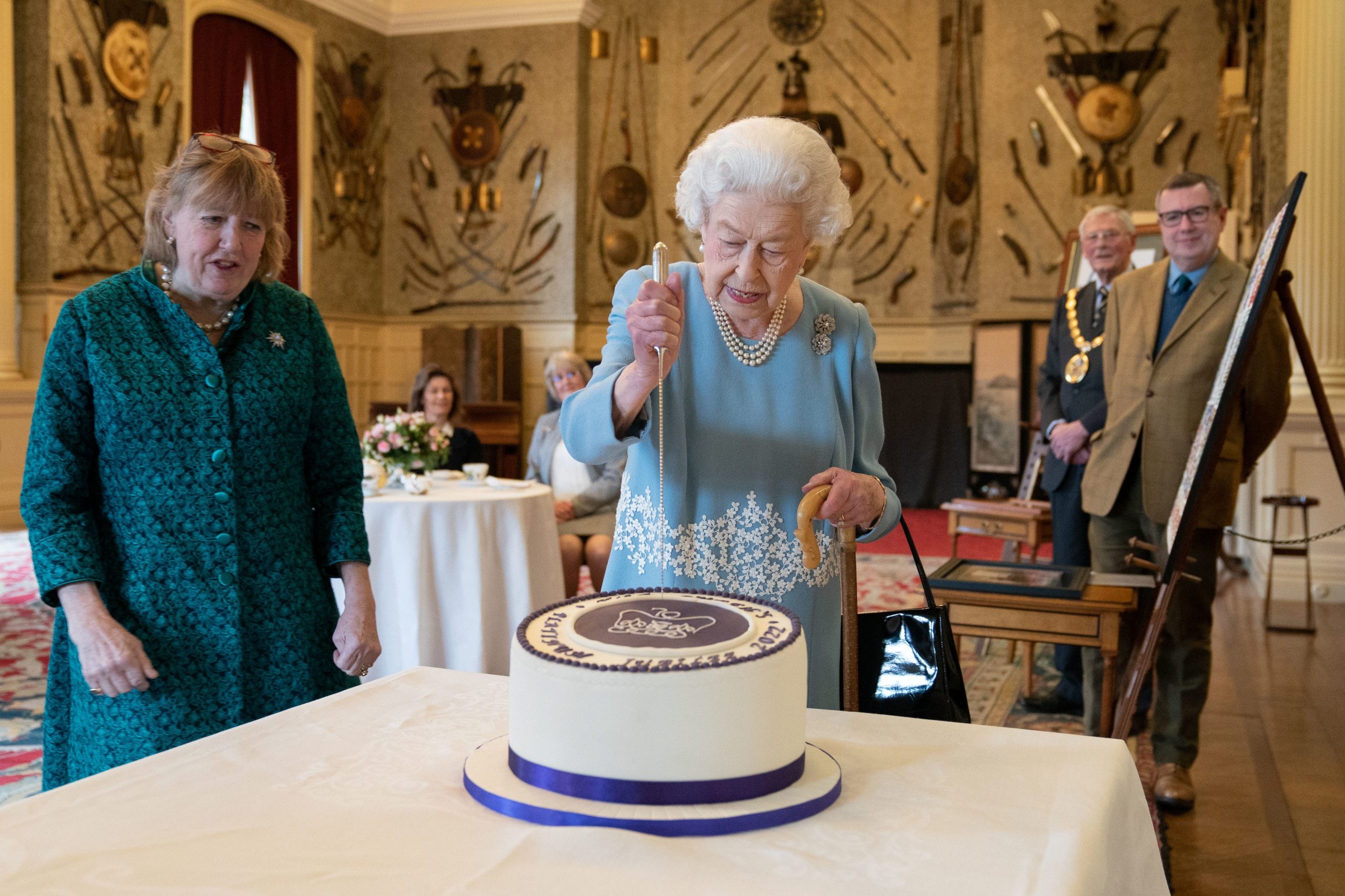 Queen Elizabeth putting a knife into her Platinum Jubilee cake at Sandringham House