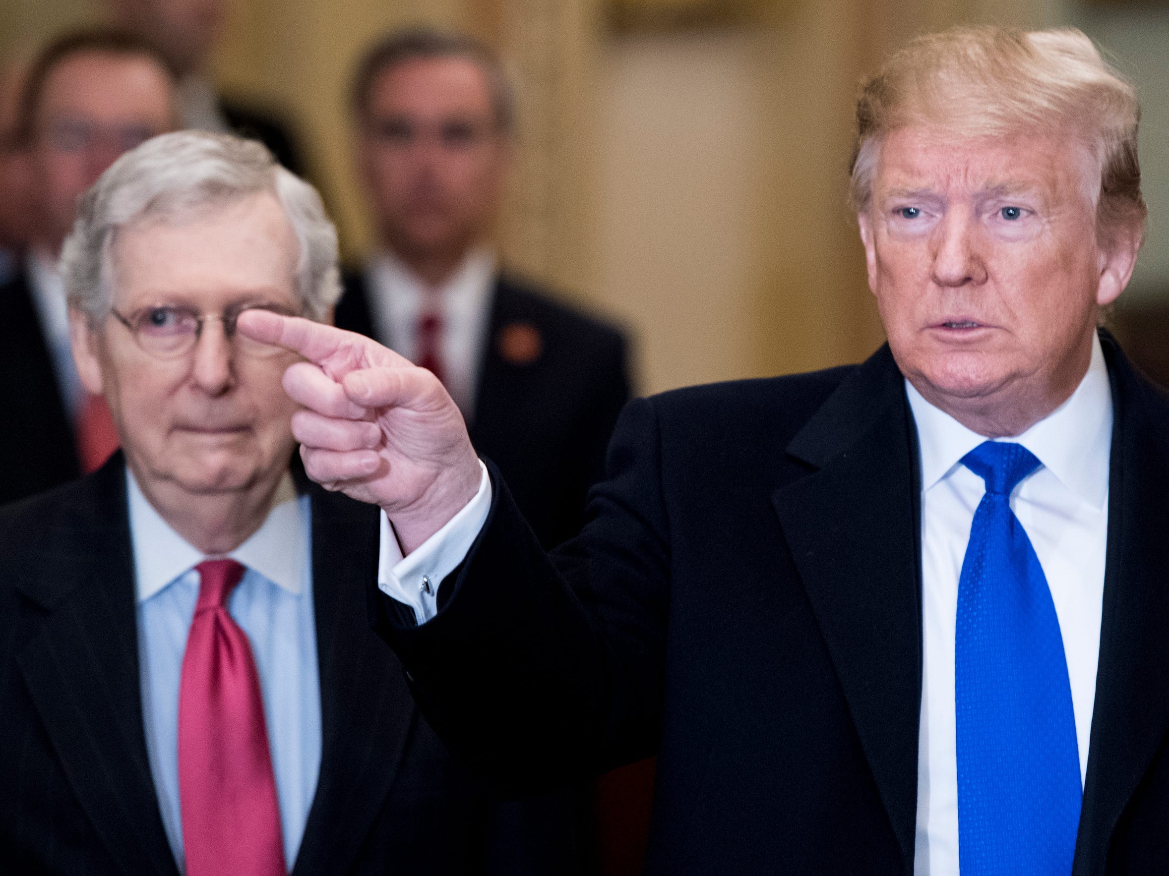 President Donald Trump takes questions from reporters he arrives with Senate Majority Leader Mitch McConnell, R-Ky., for the Senate Republicans' lunch in the Capitol on Tuesday, March 26, 2019.