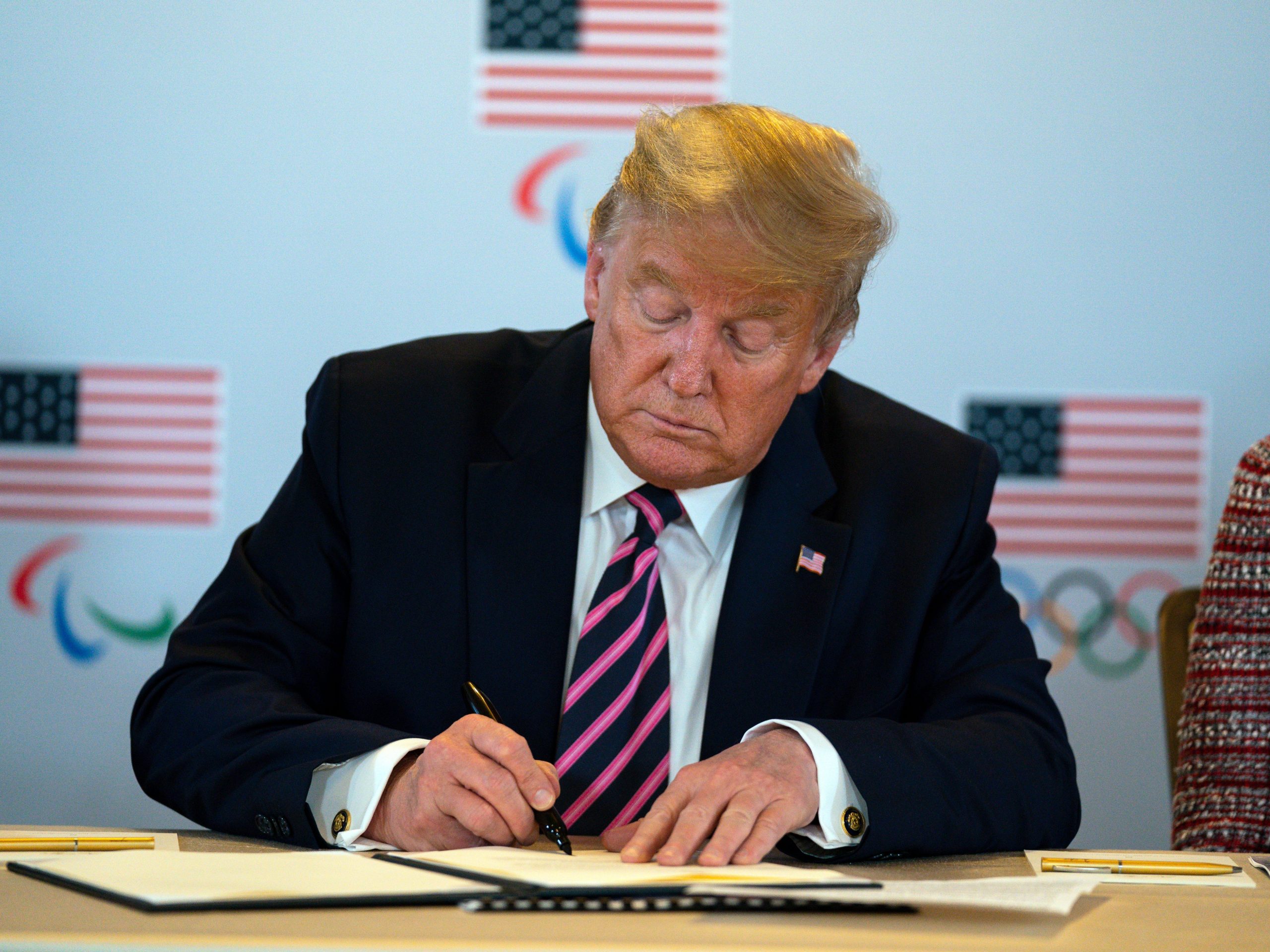 Trump signs a document