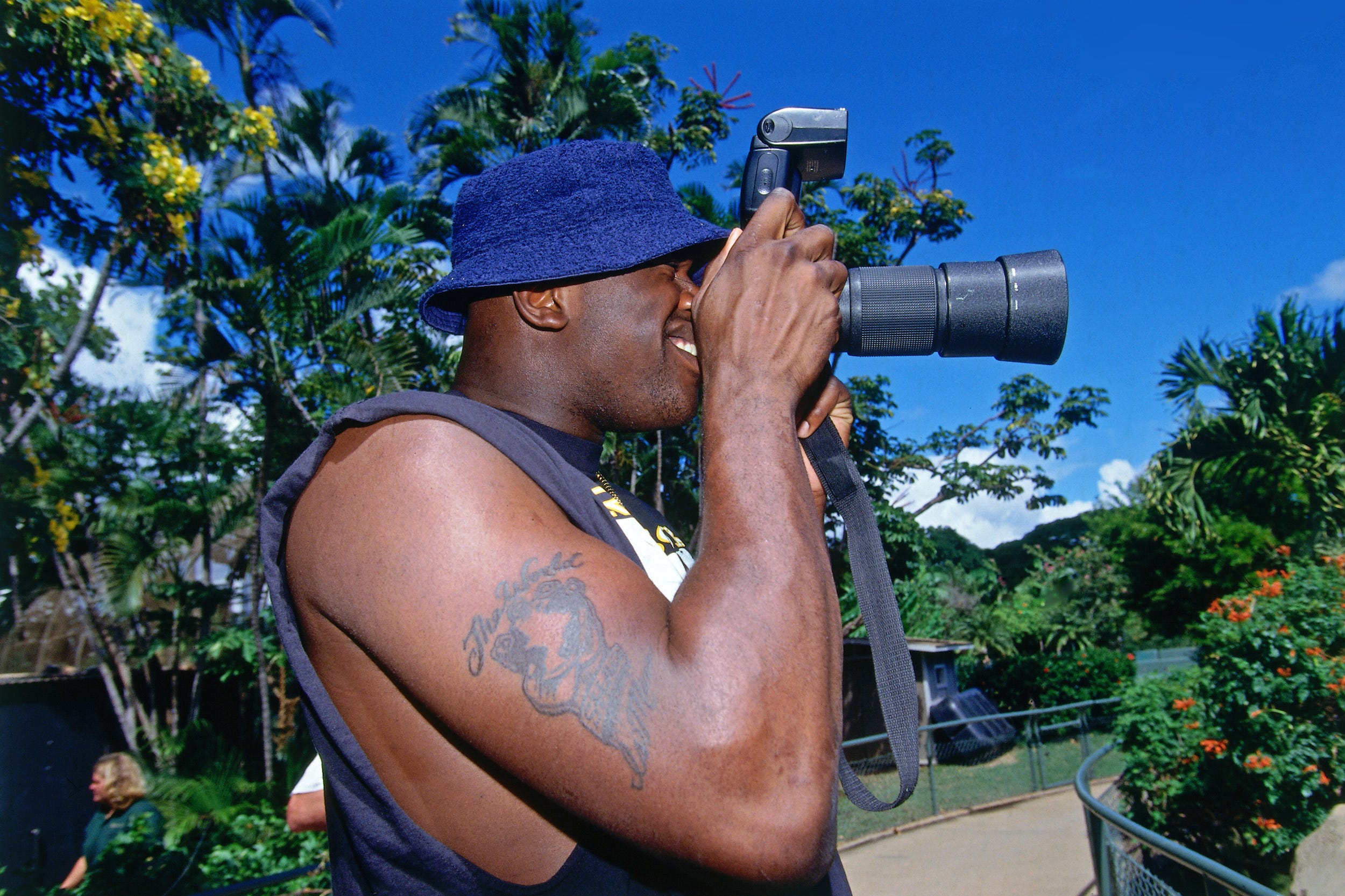 Shaq takes a photo at a zoo.