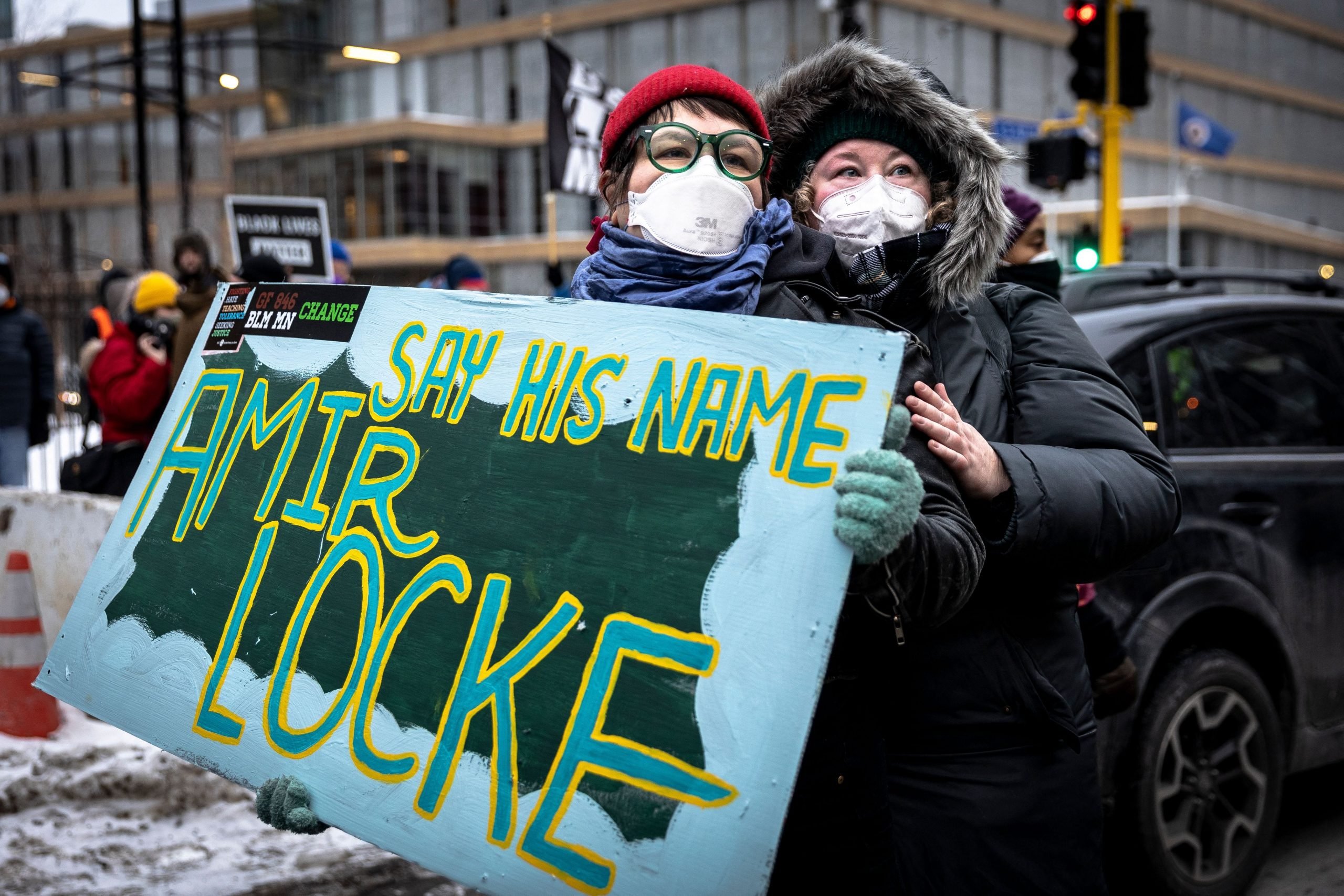 Demonstrators hold a "Say His Name" sign during a rally in protest of the killing of Amir Locke, outside the Police precint in Minneapolis, Minnesota on February 5, 2022