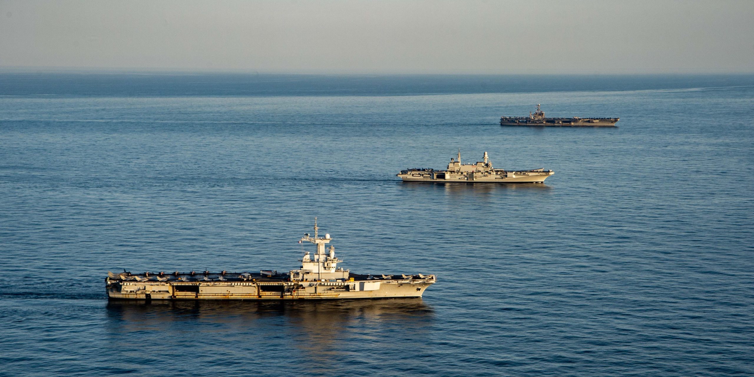 From right to left, Nimitz-class aircraft carrier USS Harry S. Truman (CVN 75), the Italian aircraft carrier ITS Cavour (C 550) and the French aircraft carrier Charles de Gaulle (R 91) transit the Mediterranean Sea in formation, Feb. 6, 2022.