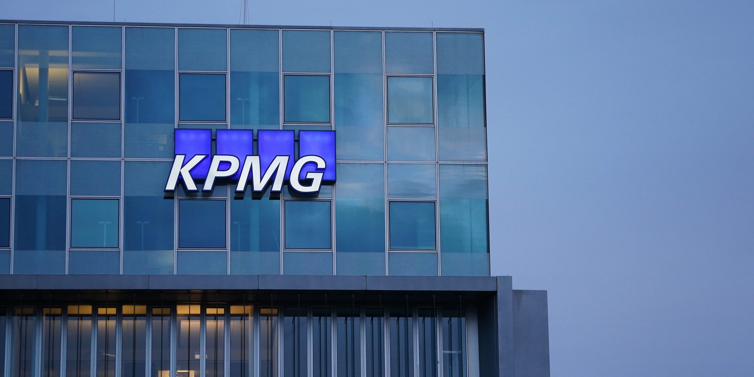 The logo of KPMG, a multinational tax advisory and accounting services company, hangs on the facade of a KPMG offices building on January 22, 2021 in Berlin, Germany.
