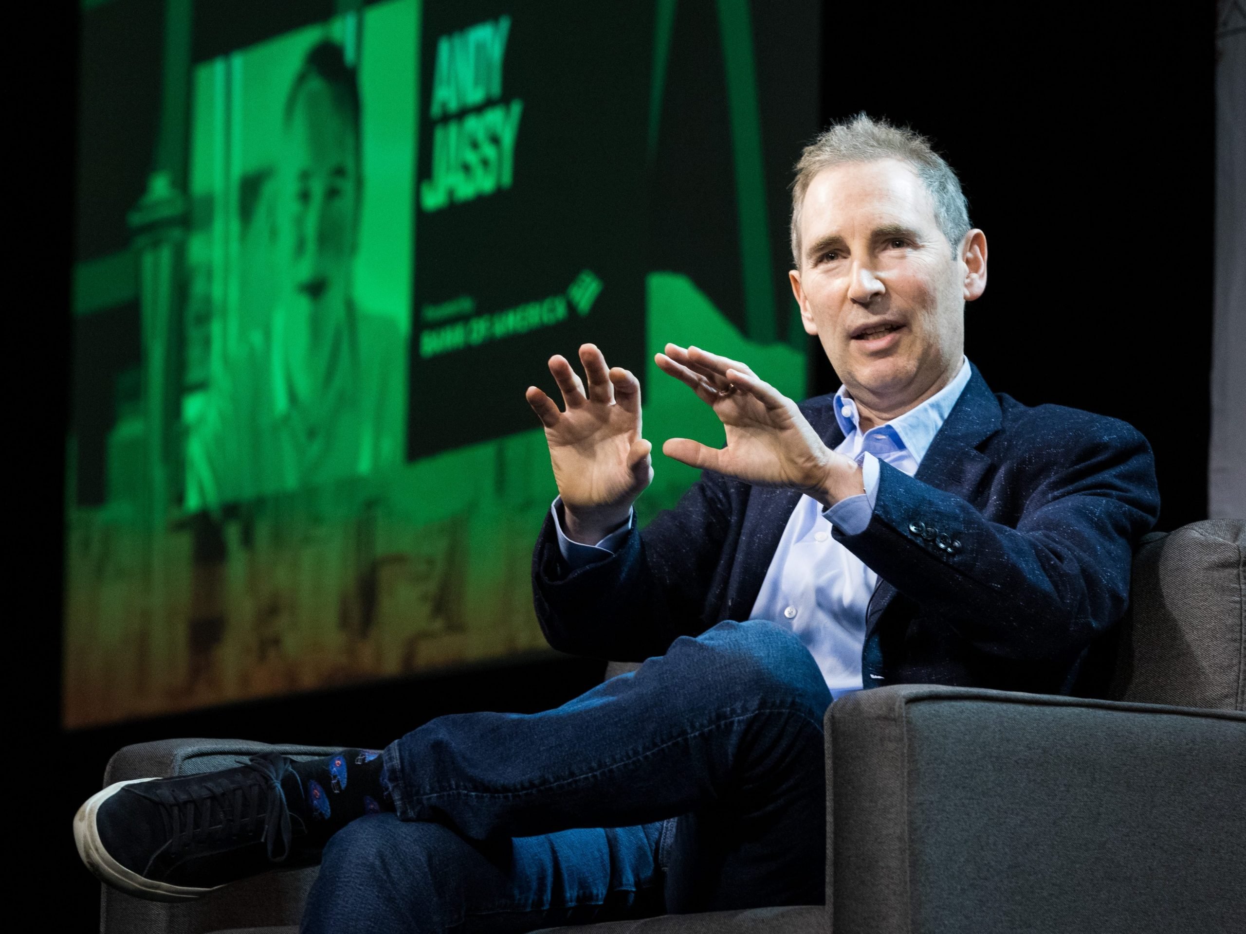 Amazon CEO Andy Jassy motions with his hands on stage at the GeekWire Summit.