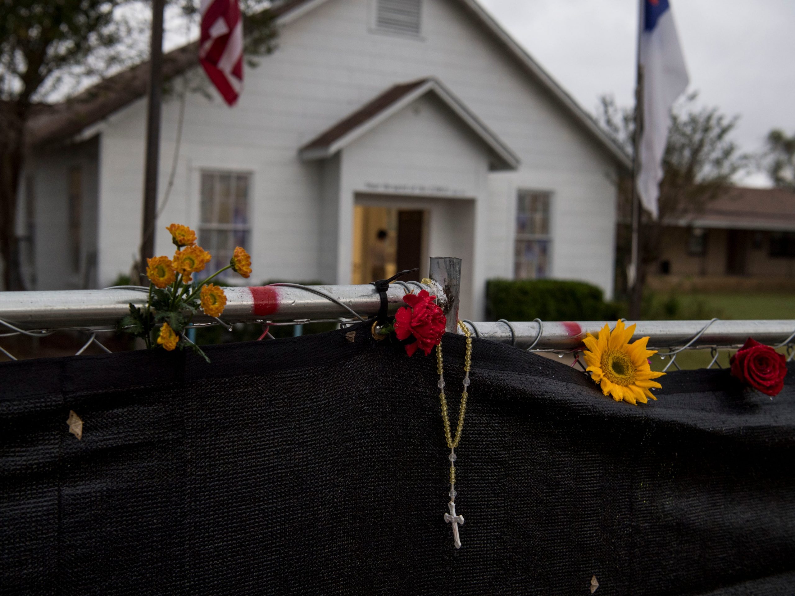 A rosary seen hanging on a fence outside the First Baptist Church in Sutherland Springs a week after the shooting.