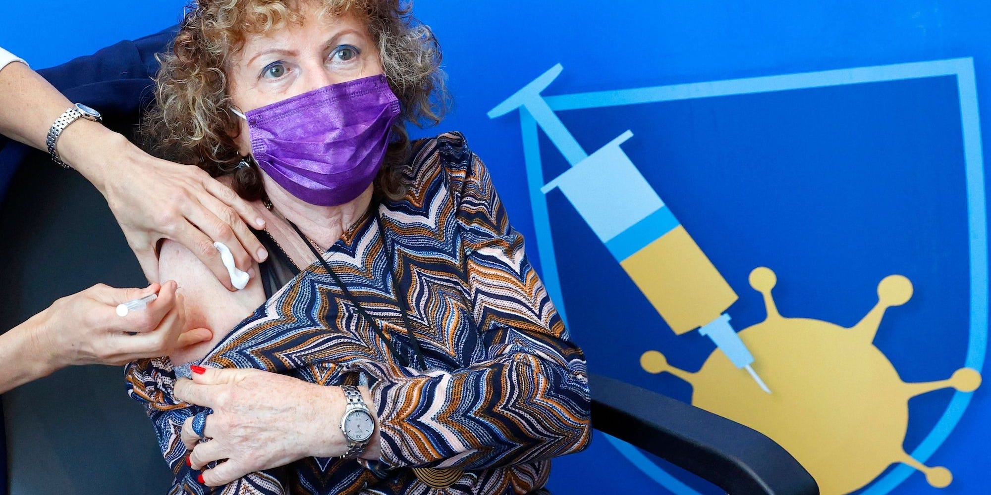 A woman in Israel gets a booster shot.