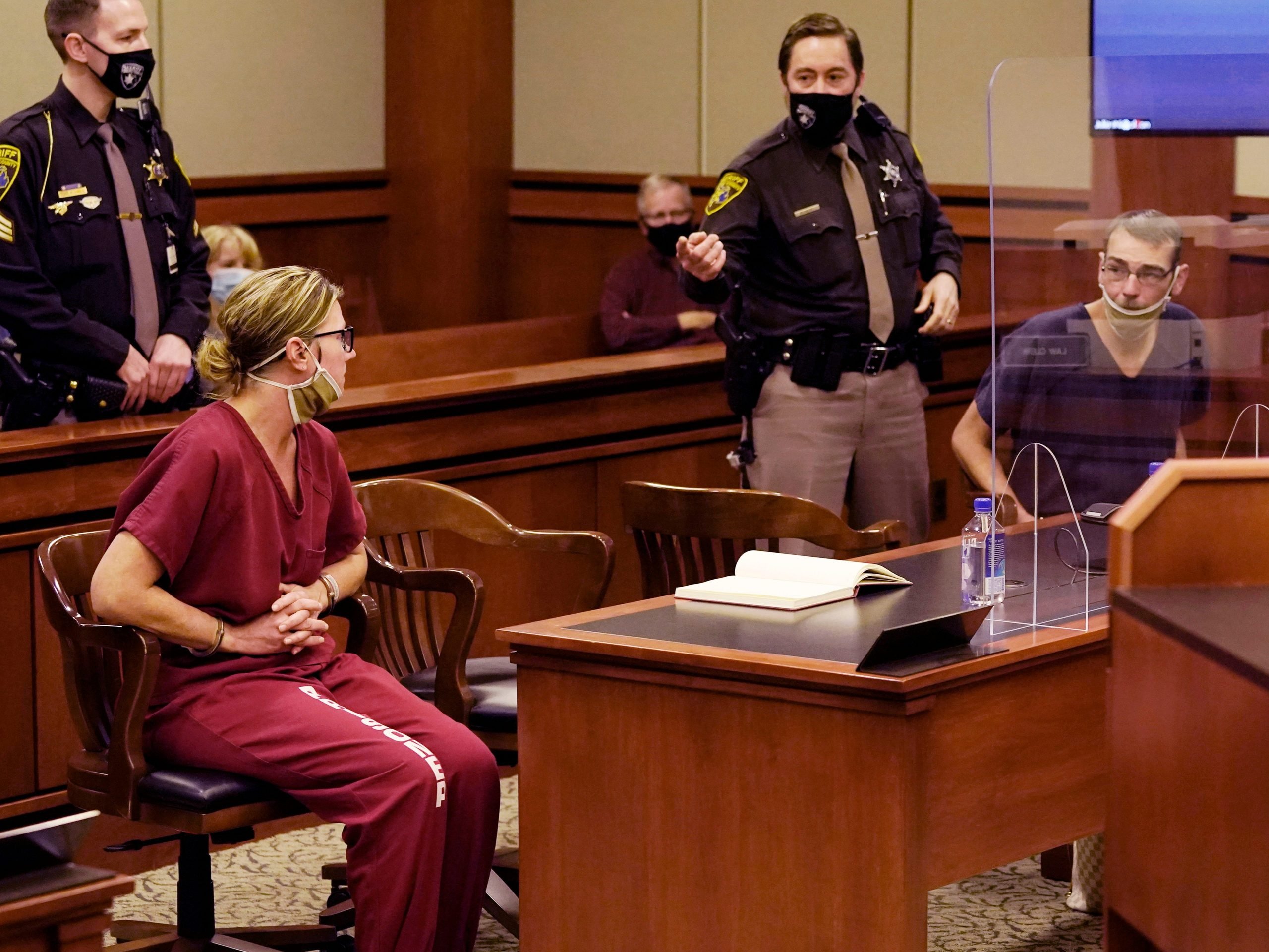 James Crumbley, right, looks towards his wife Jennifer Crumbley during a court hearing in Rochester Hills, Mich., Dec. 14, 2021.