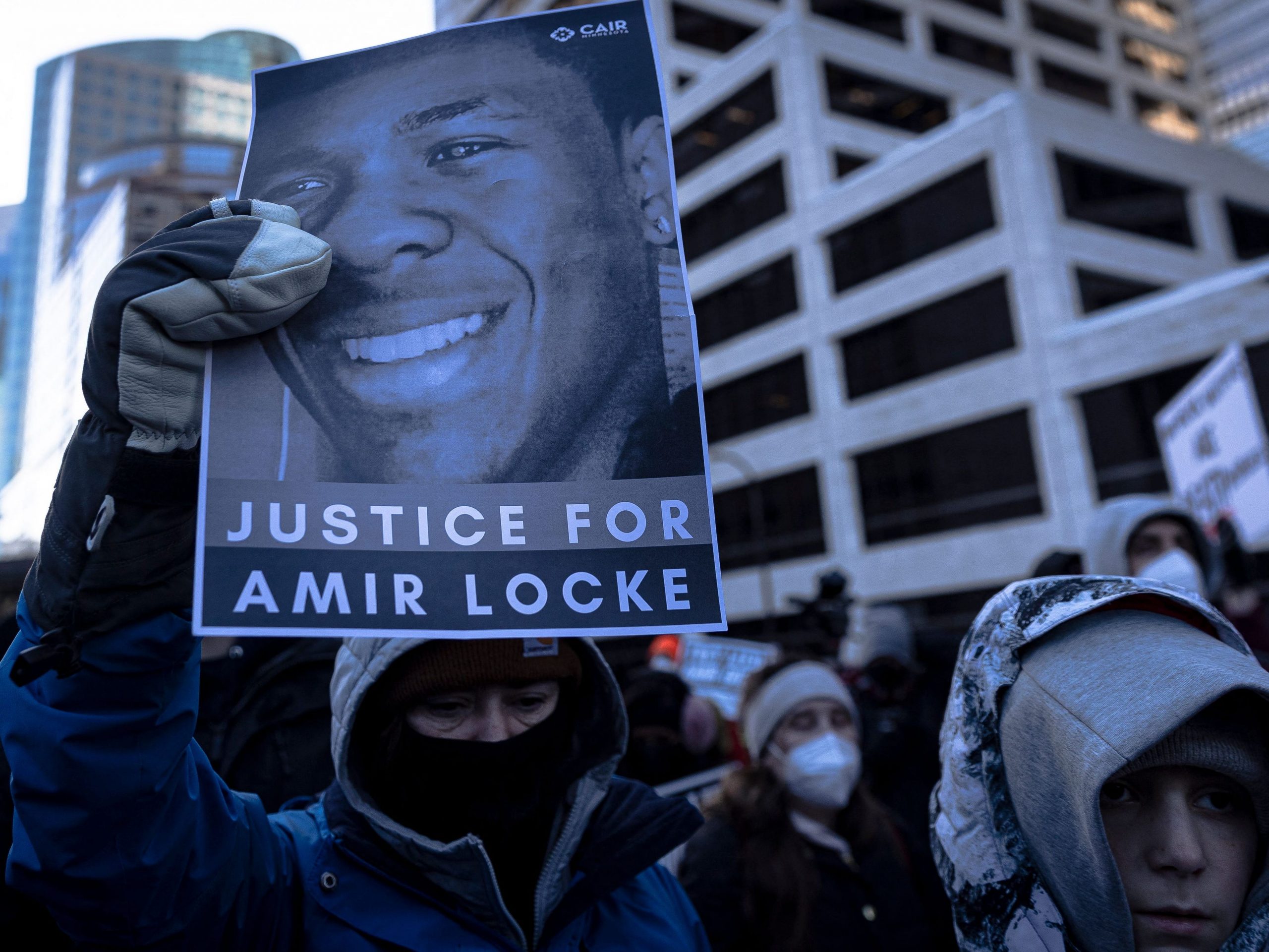 A demonstrator holds a photo of Amir Locke during a rally in protest of his killing, outside the Hennepin County Government Center in Minneapolis, Minnesota on February 5, 2022.