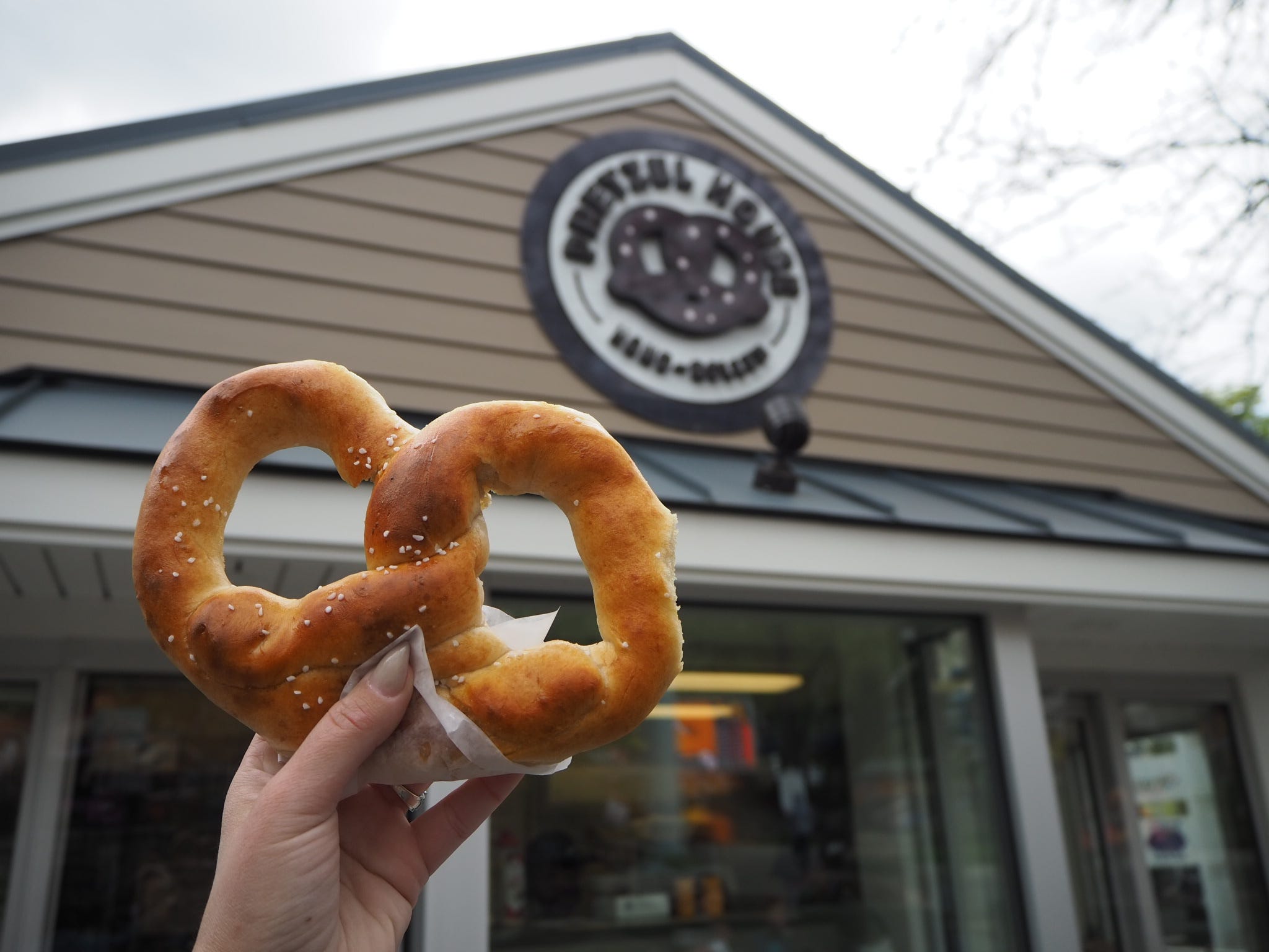 The writer holds a Hersheypark pretzel