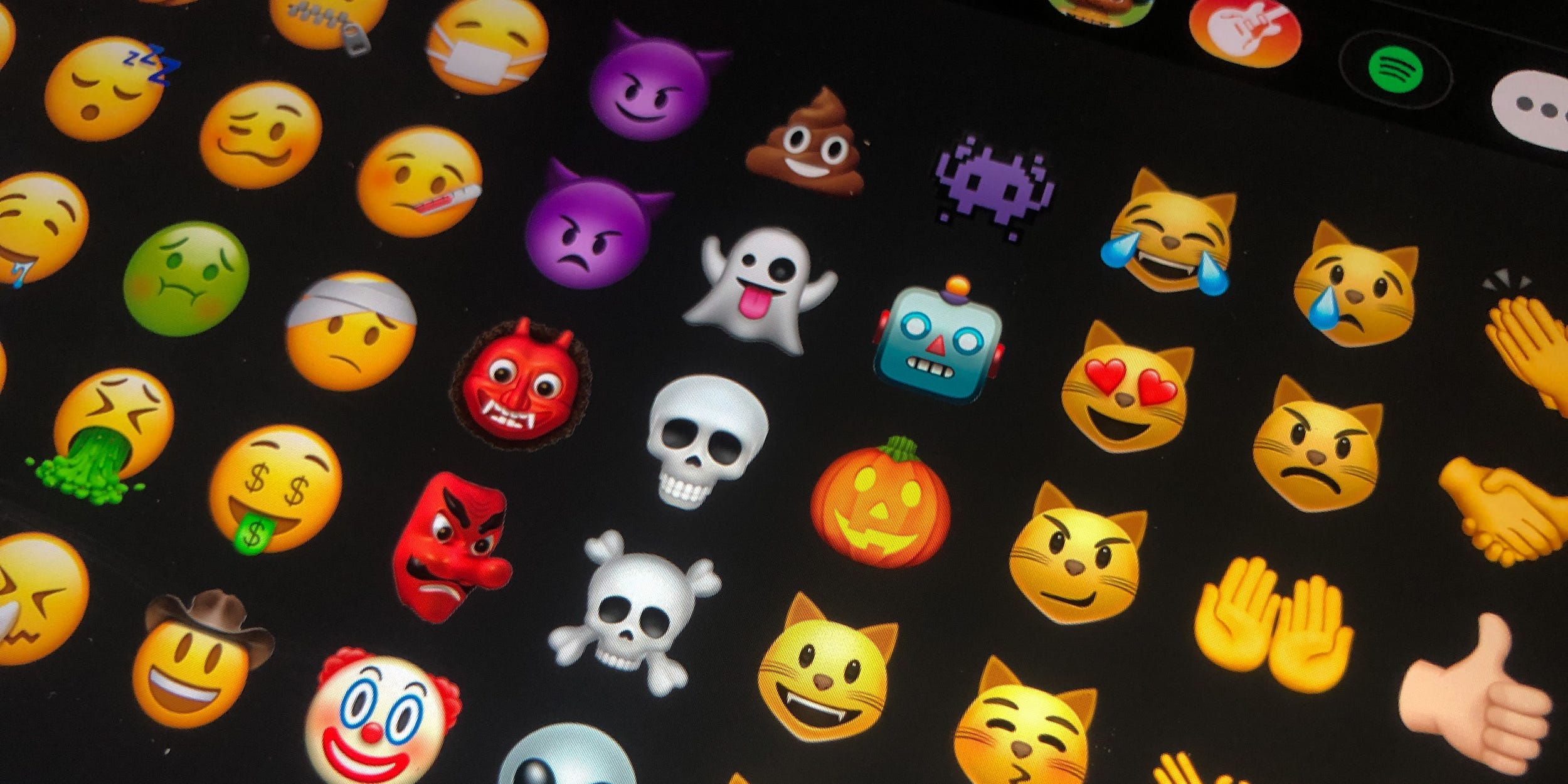 An iPhone screen showing rows of emoji inside the messages app