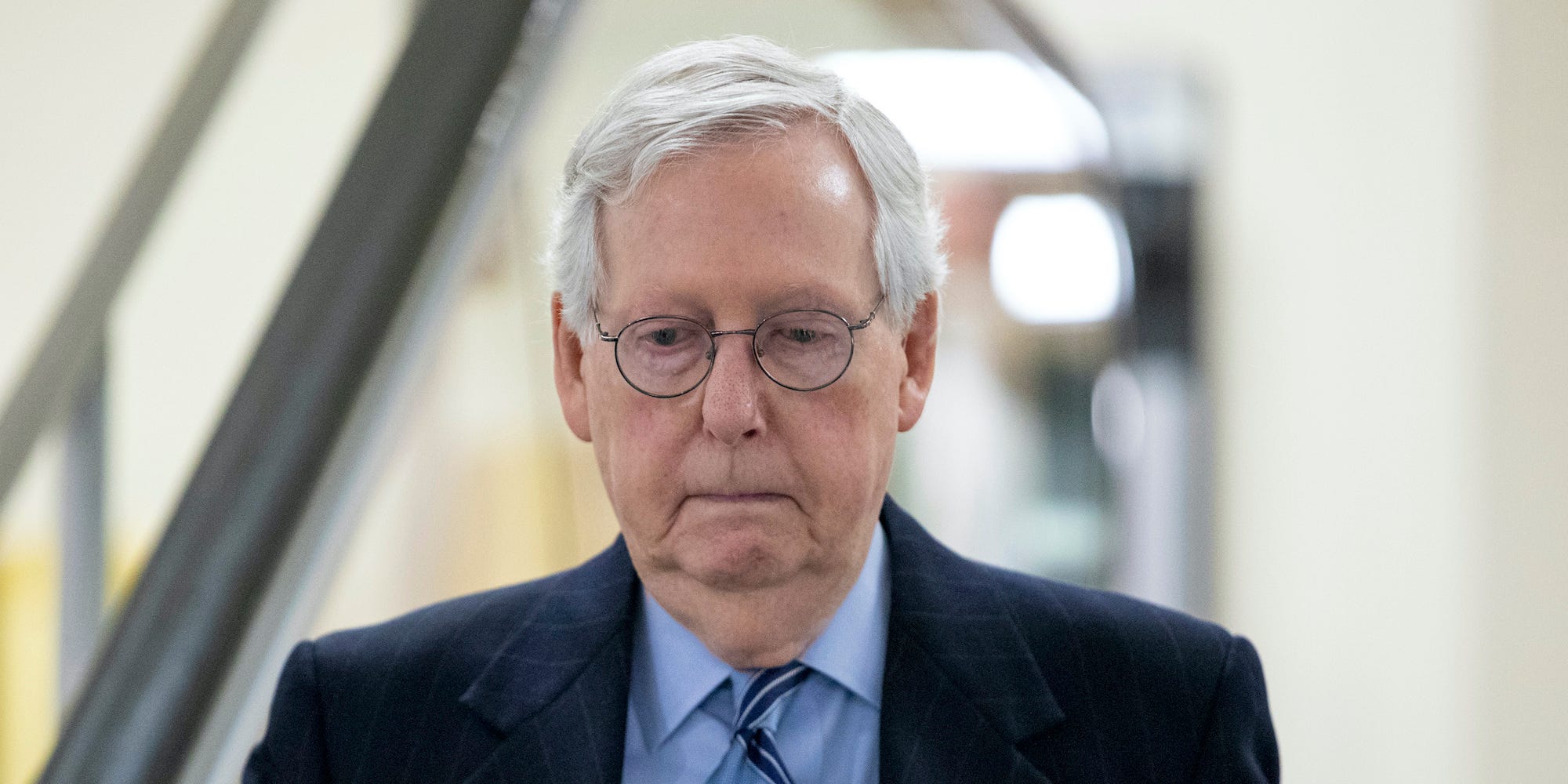Senate Minority Leader Mitch McConnell, R-Ky. goes down an escalator at the Capitol in Washington, Wednesday, Jan. 19, 2022.