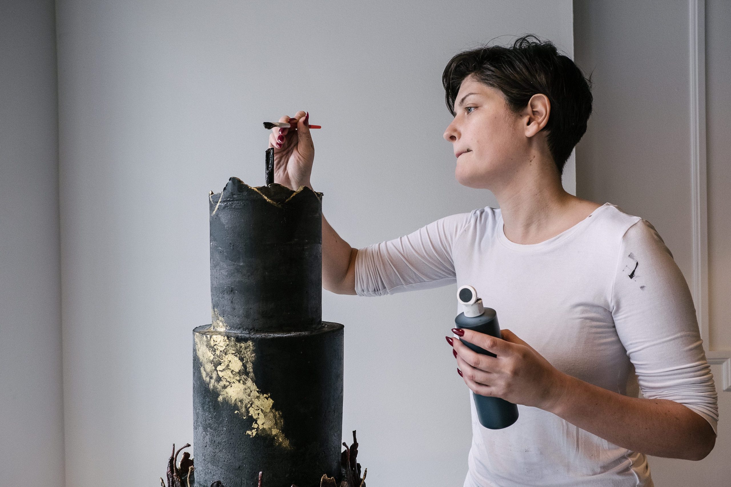 Justine Martin, who owns Guilty Pleasures Bakeshop, decorating a cake.