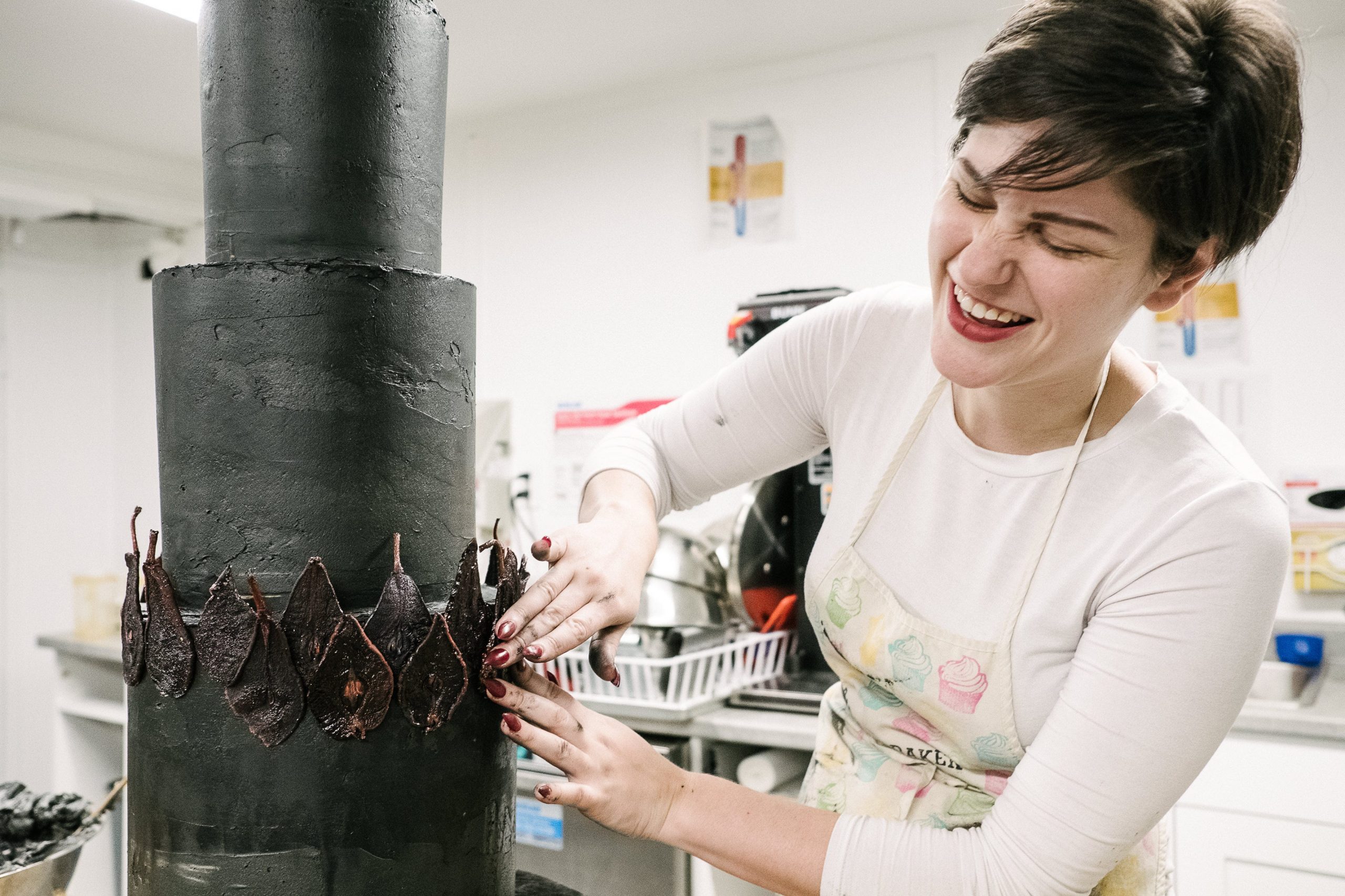 Justine Martin, who owns Guilty Pleasures Bakeshop, decorating a cake.