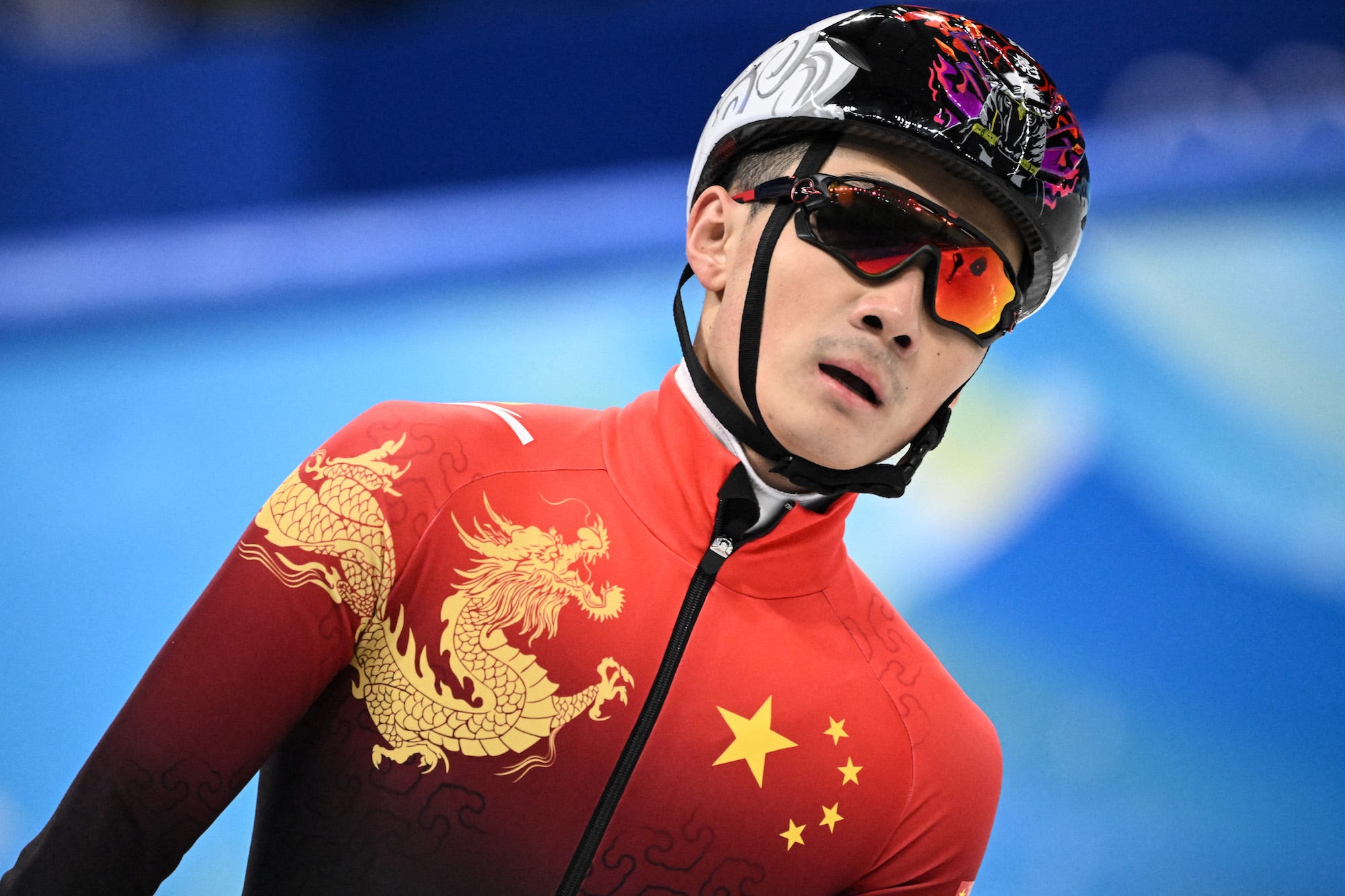 China's Ren Ziwei reacts after competing in a quarter-final heat of the men's 1500m short track speed skating event during the Beijing 2022 Winter Olympic Games at the Capital Indoor Stadium in Beijing