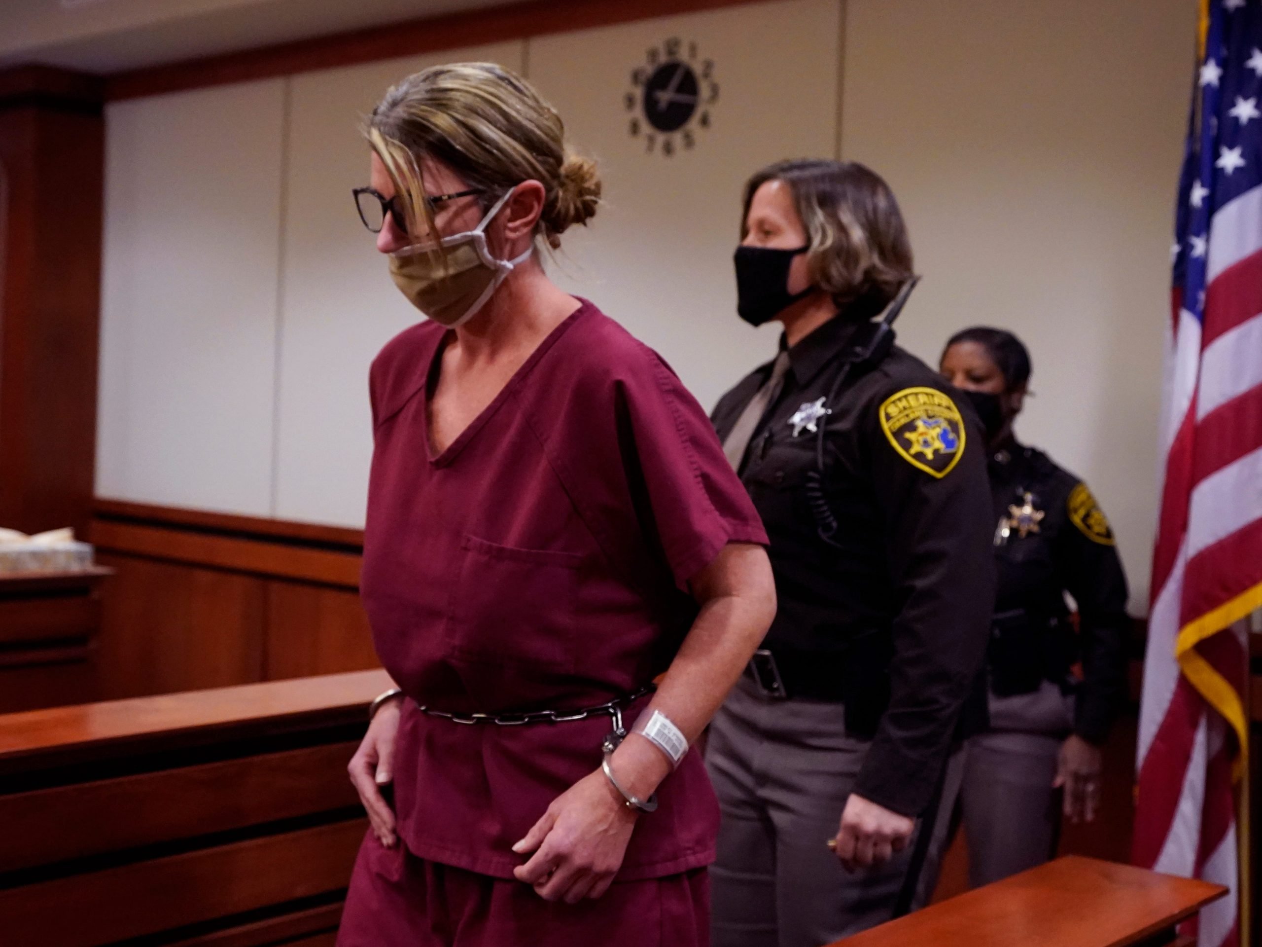 Jennifer Crumbley is escorted into court for a probable cause hearing in Rochester Hills, Mich., Tuesday, Dec. 14, 2021.