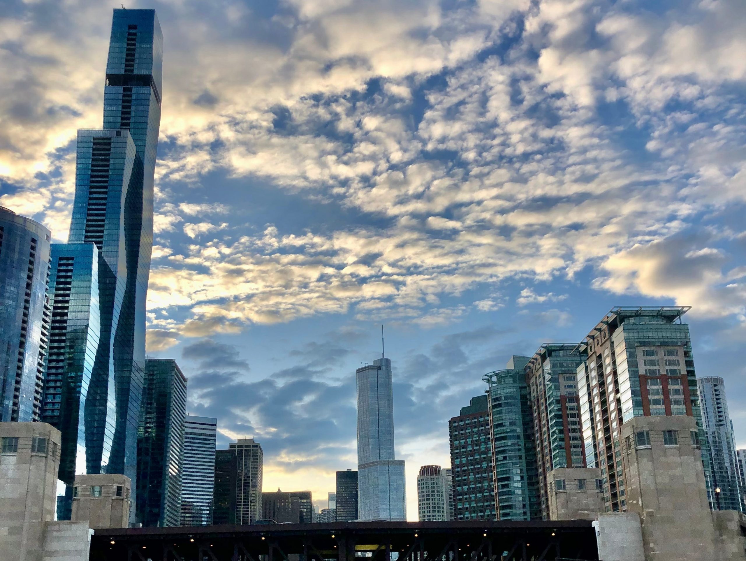 portion of the chicago skyline from the river at sunset