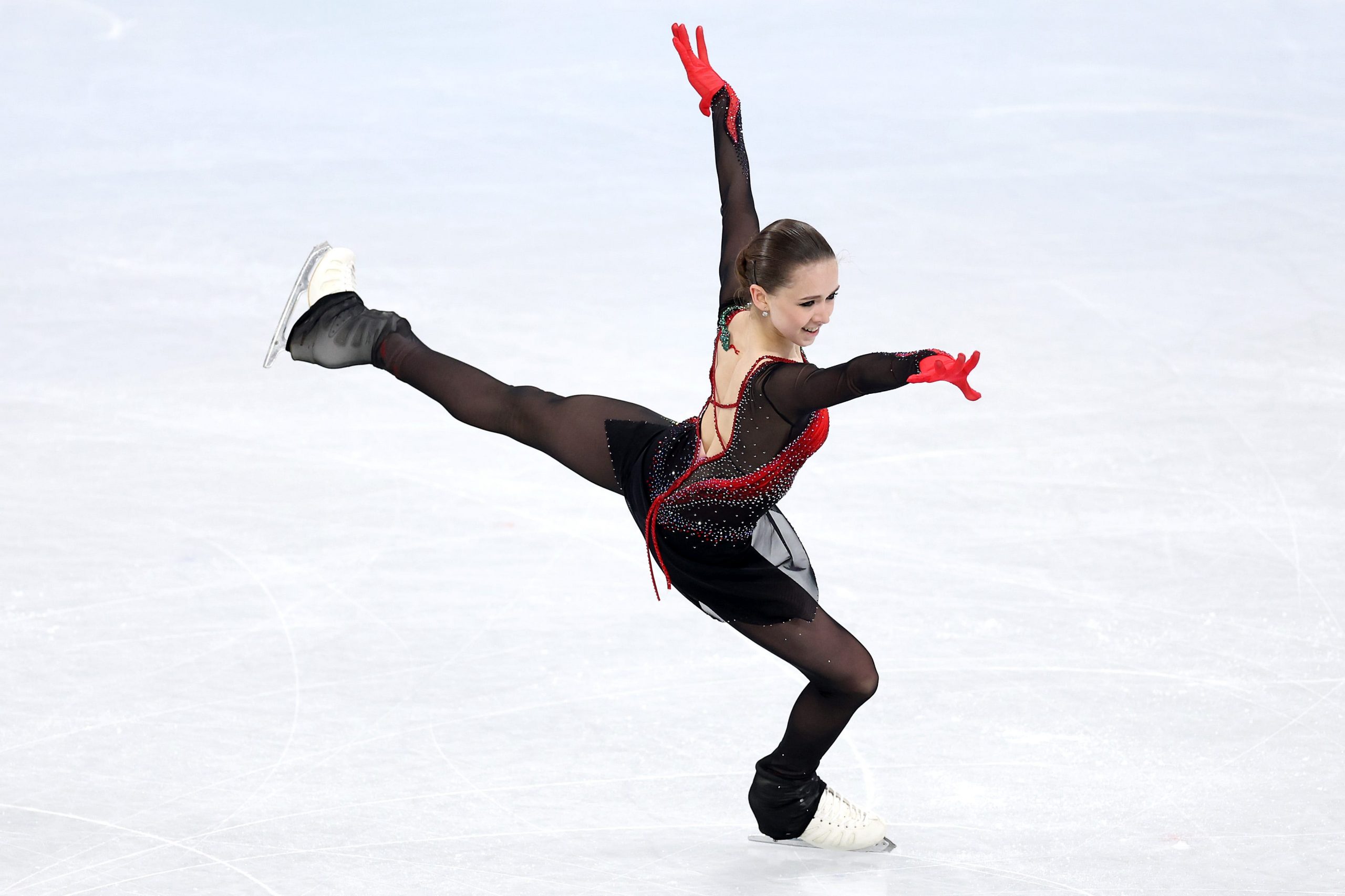 Kamila Valieva smiles at judges during performance at the 2022 Winter Olympics