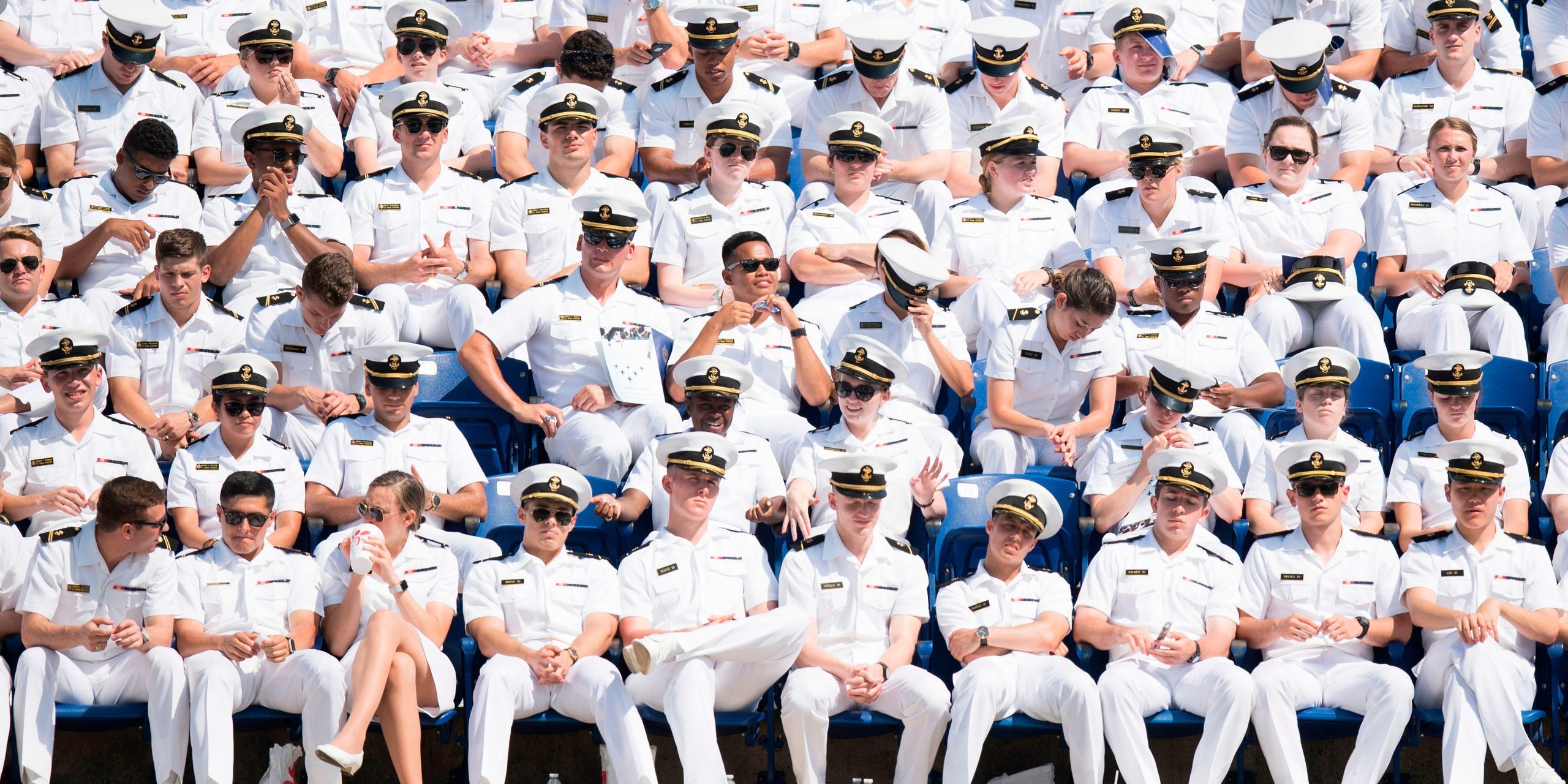 United States Naval Academy midshipmen sit in the stands waiting for the USNA graduation ceremony to begin in Annapolis, Maryland on May 25, 2018.