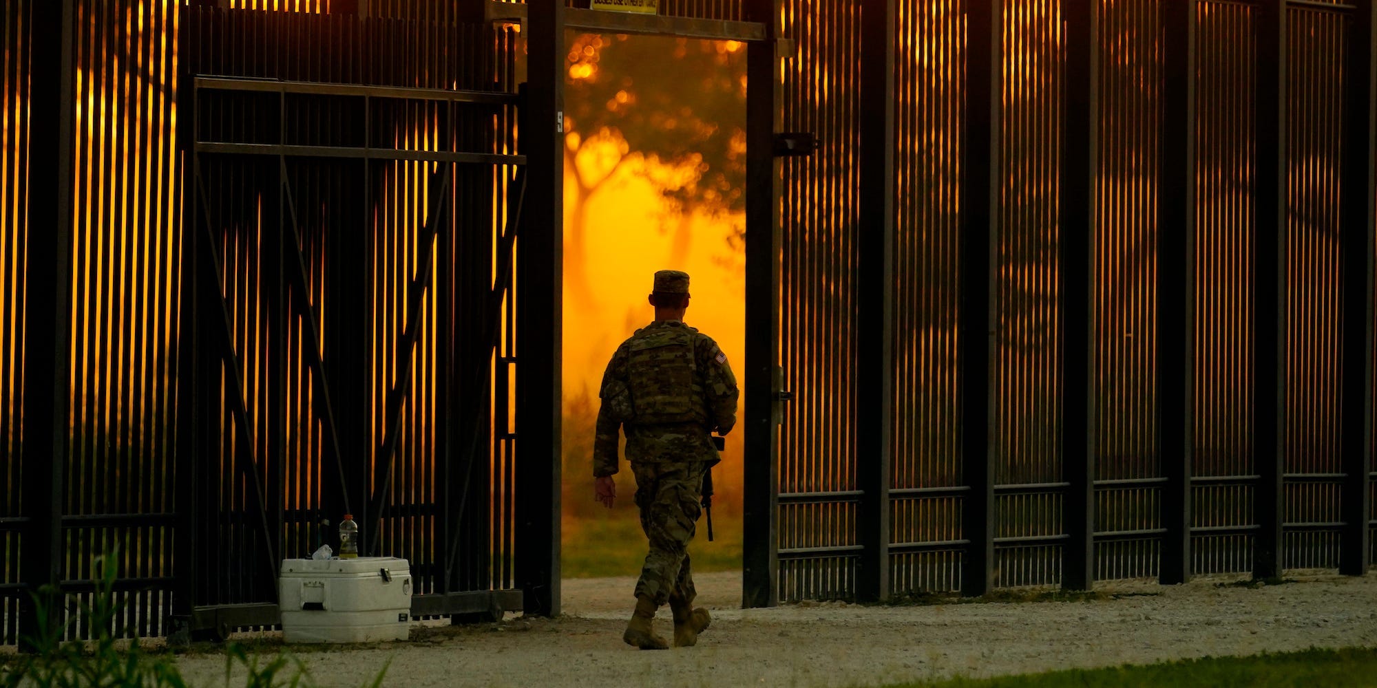 A National Guardsman stands guard at a fence that runs along the Rio Grande near the International bridge, Friday, Sept. 17, 2021, in Del Rio, Texas.