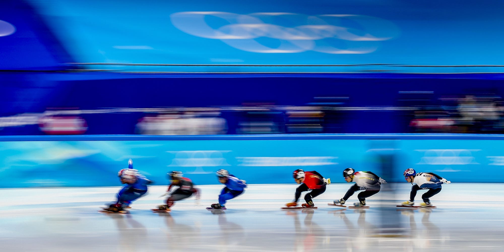 Speed skaters compete in the Olympics.