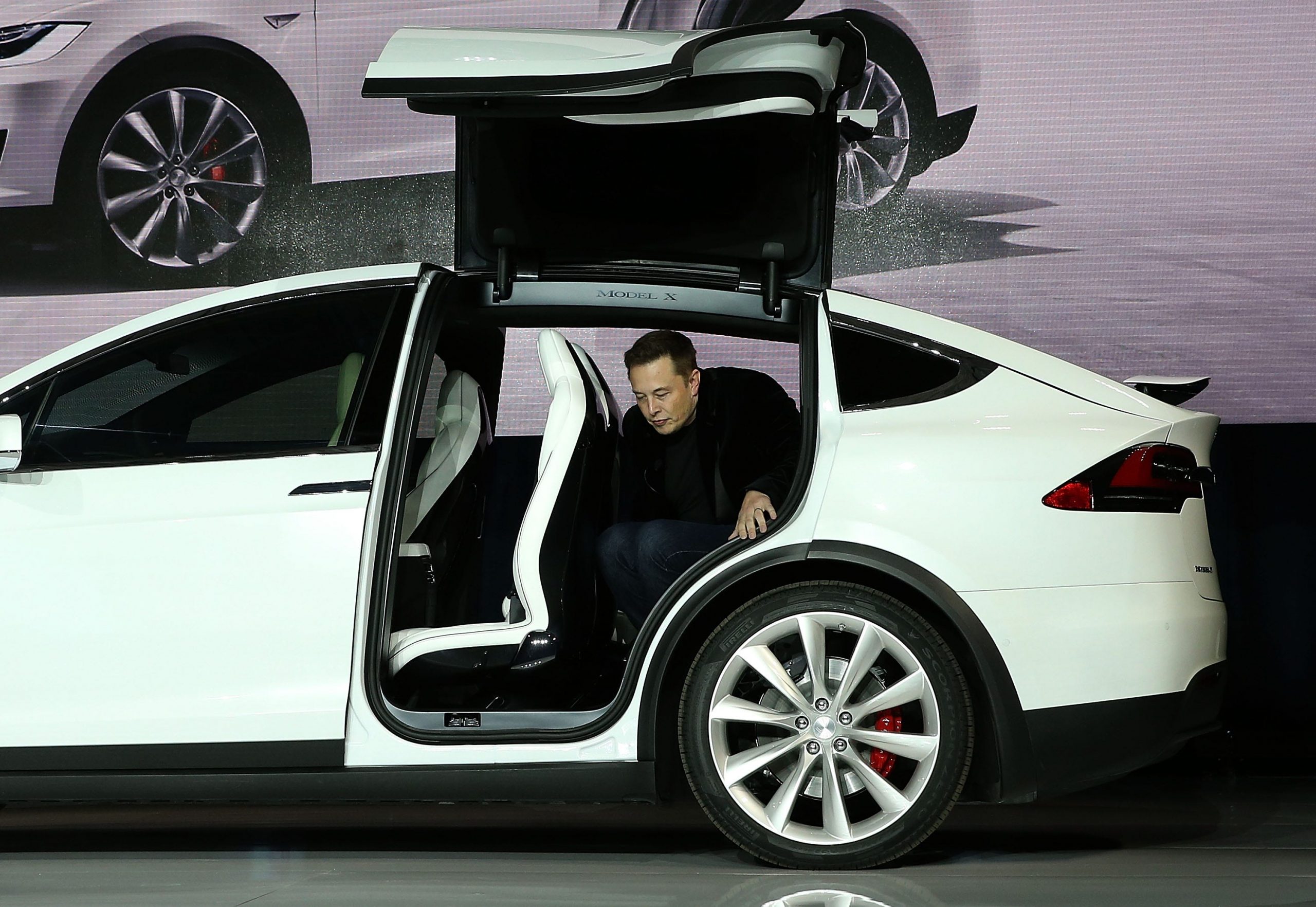 Tesla CEO Elon Musk steps out of the new Tesla Model X during an event to launch the company's new crossover SUV on September 29, 2015 in Fremont, California.