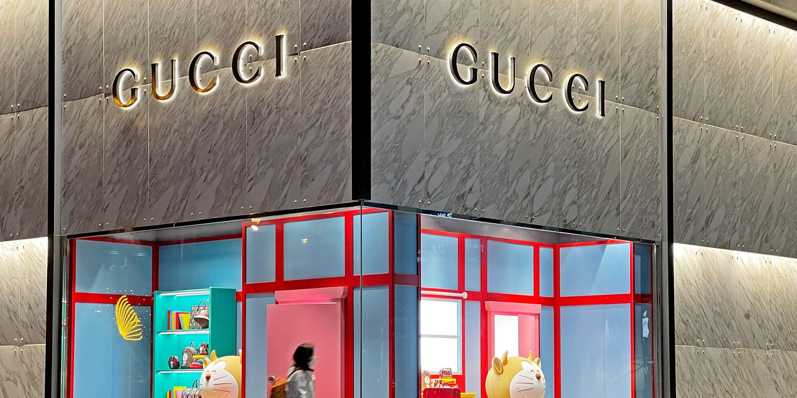 A pedestrian walks past Doraemon figures on display in the window of a Guccio Gucci SpA luxury goods store to mark the Chinese New Year, the Year of the Ox, on January 27, 2021 in Beijing, China.