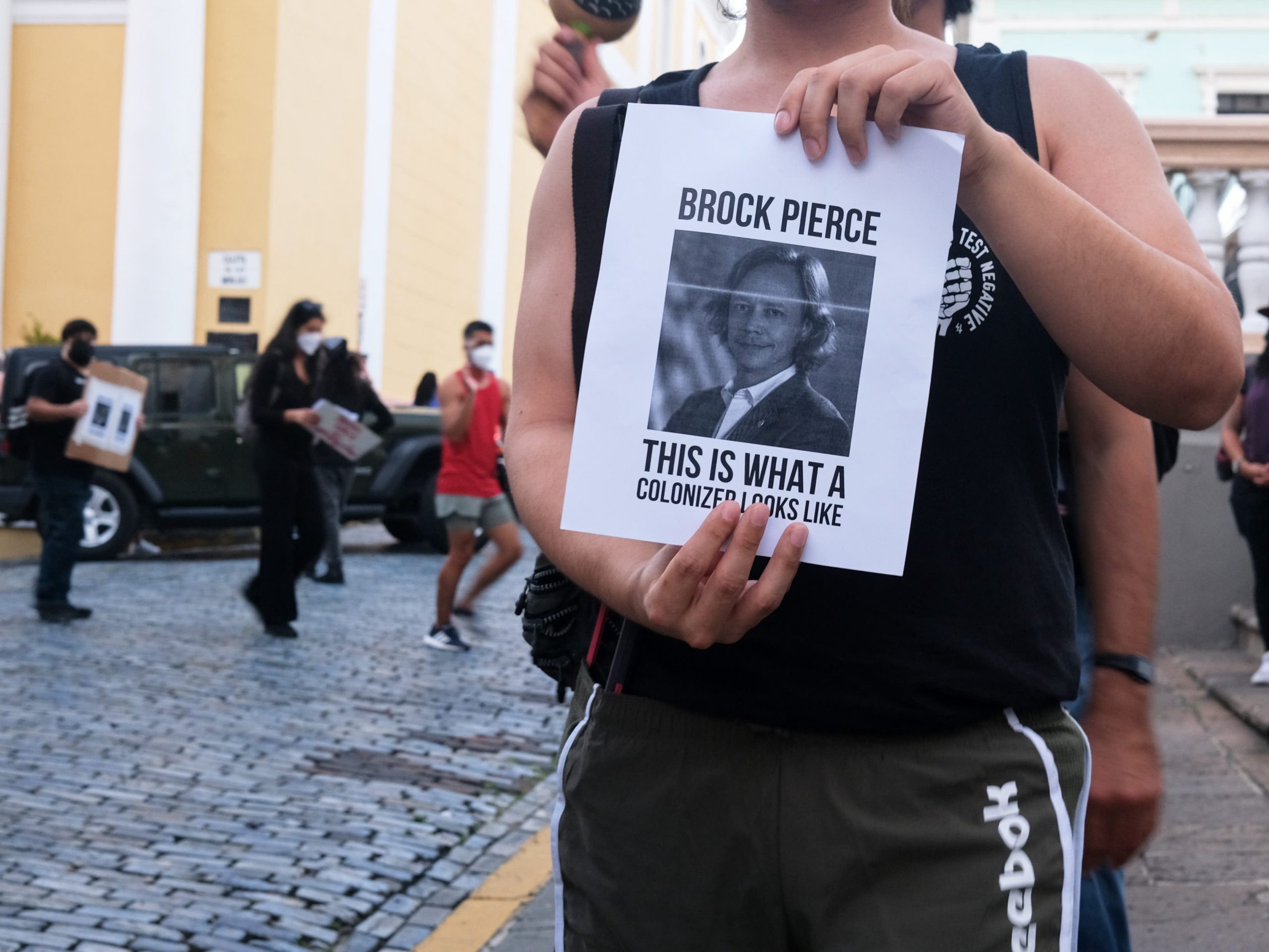 The protest was held in front of Brock Pierce's "crypto club house," a former children's museum.