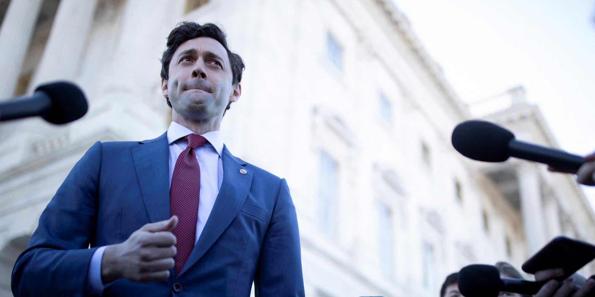 Democratic Sen. Jon Ossoff of Georgia speaks to reporters about the Ban Congressional Stock Trading Act outside the Capitol on February 9, 2022.