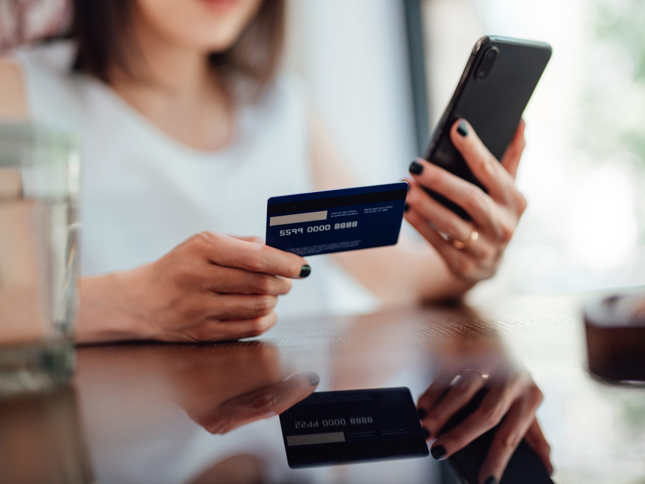 woman holds credit card