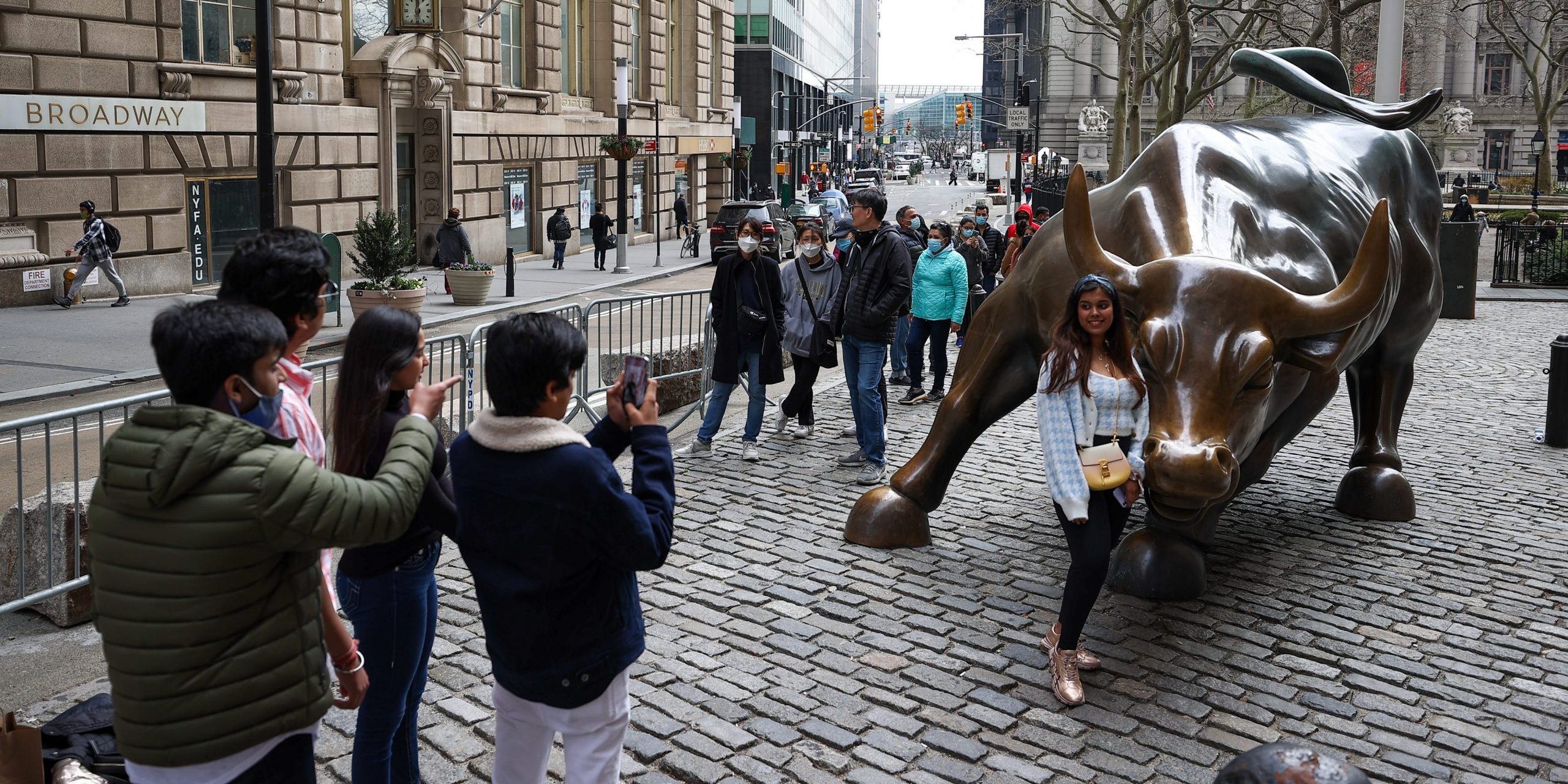 NEW YORK, USA - MARCH 25: Tourists that lined up for take a photo of the Charging Bull are seen during COVID-19 pandemic in New York City, United States on March 25, 2021. (Photo by Tayfun Coskun/Anadolu Agency via Getty Images)