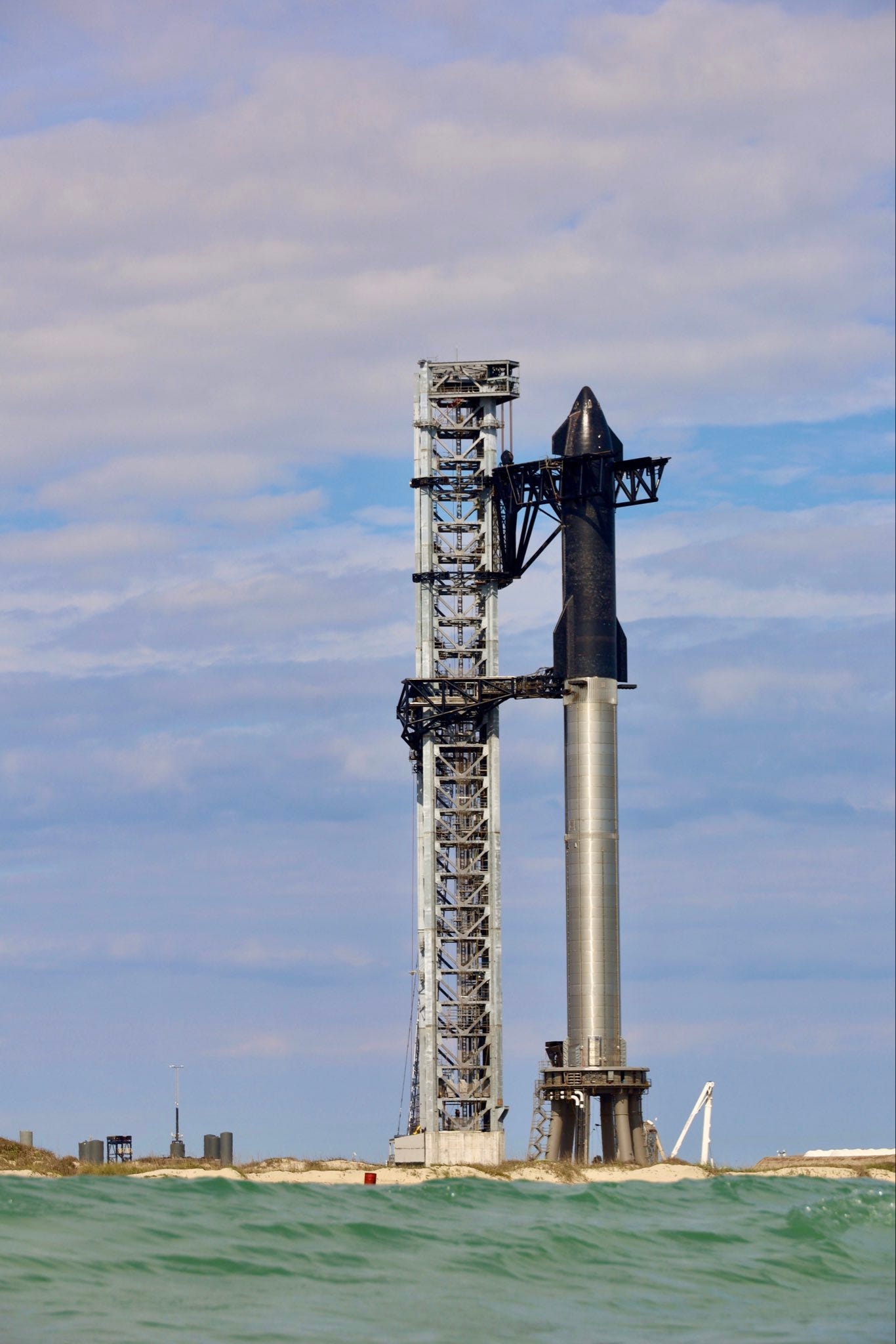 starship stacked on top of 23-story booster at launch site tower in boca chica texas