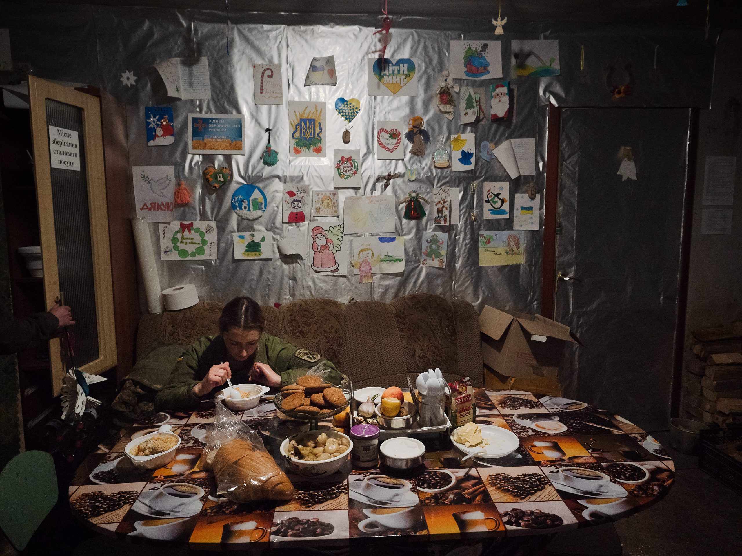 Alena, 32, a press officer in the Ukrainian army, takes a break in the soldiers lunch room on February 9, 2022 in Pisky, Ukraine.