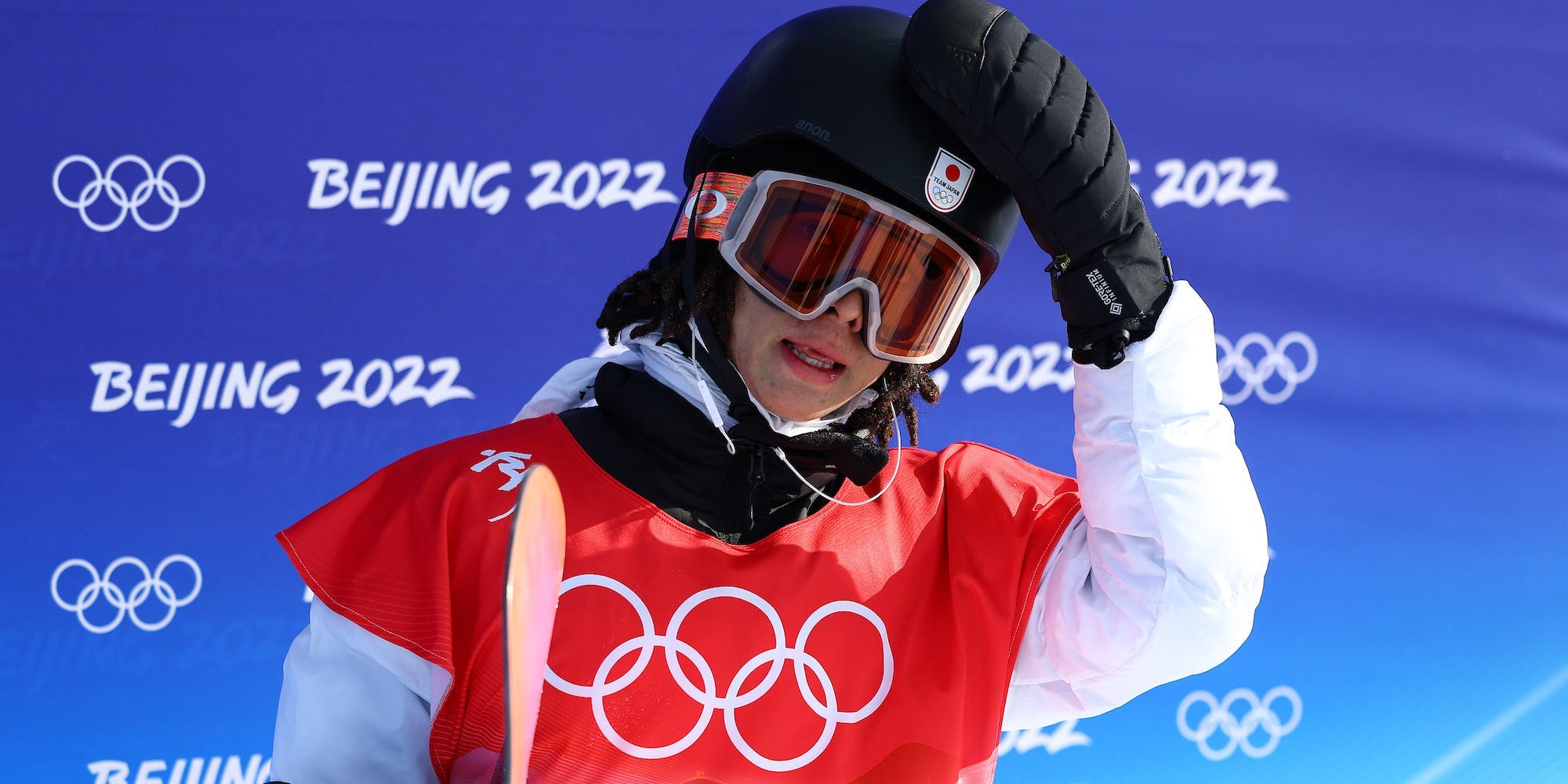 Ayumu Hirano touches his helmet after a run at the Beijing Olympics.