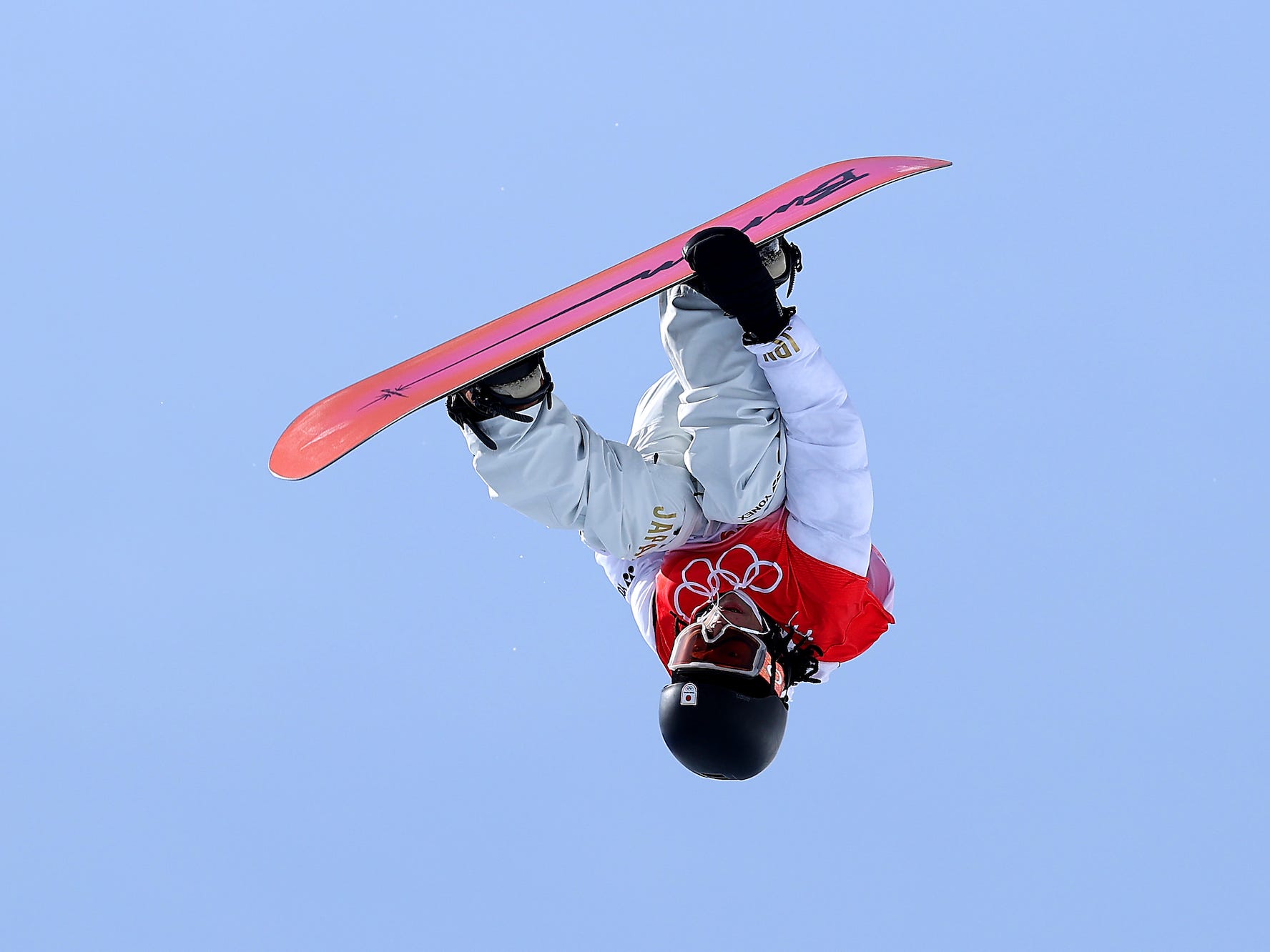 Ayumu Hirano flips upside down during a run at the Beijing Olympics.