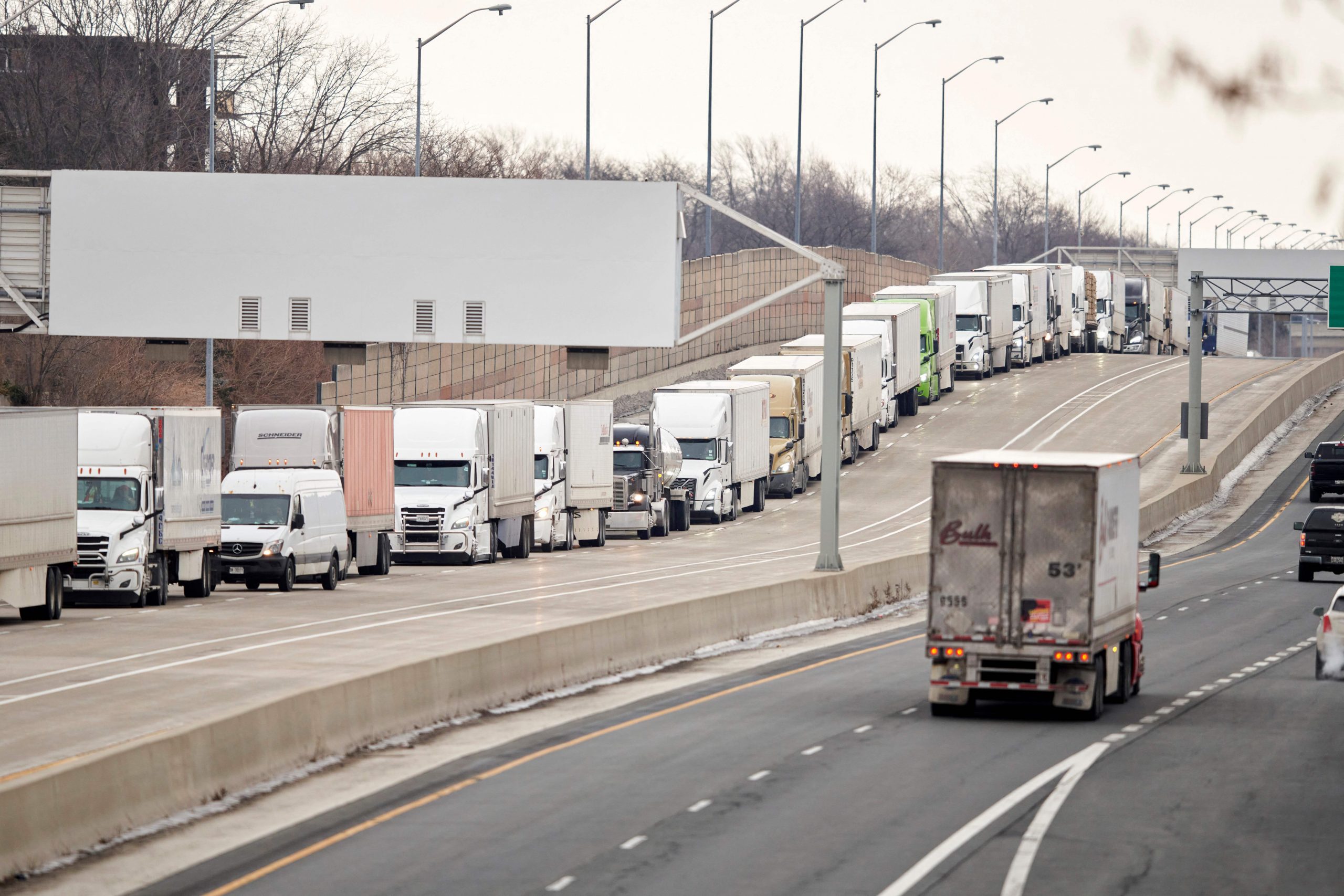 Trucks wait in line on Highway 402 to cross into the United States at the Bluewater Bridge has been forced to take almost all of the truck traffic between Ontario and Michigan after protestors blockaded the Ambassador Bridge in Windsor this week. which