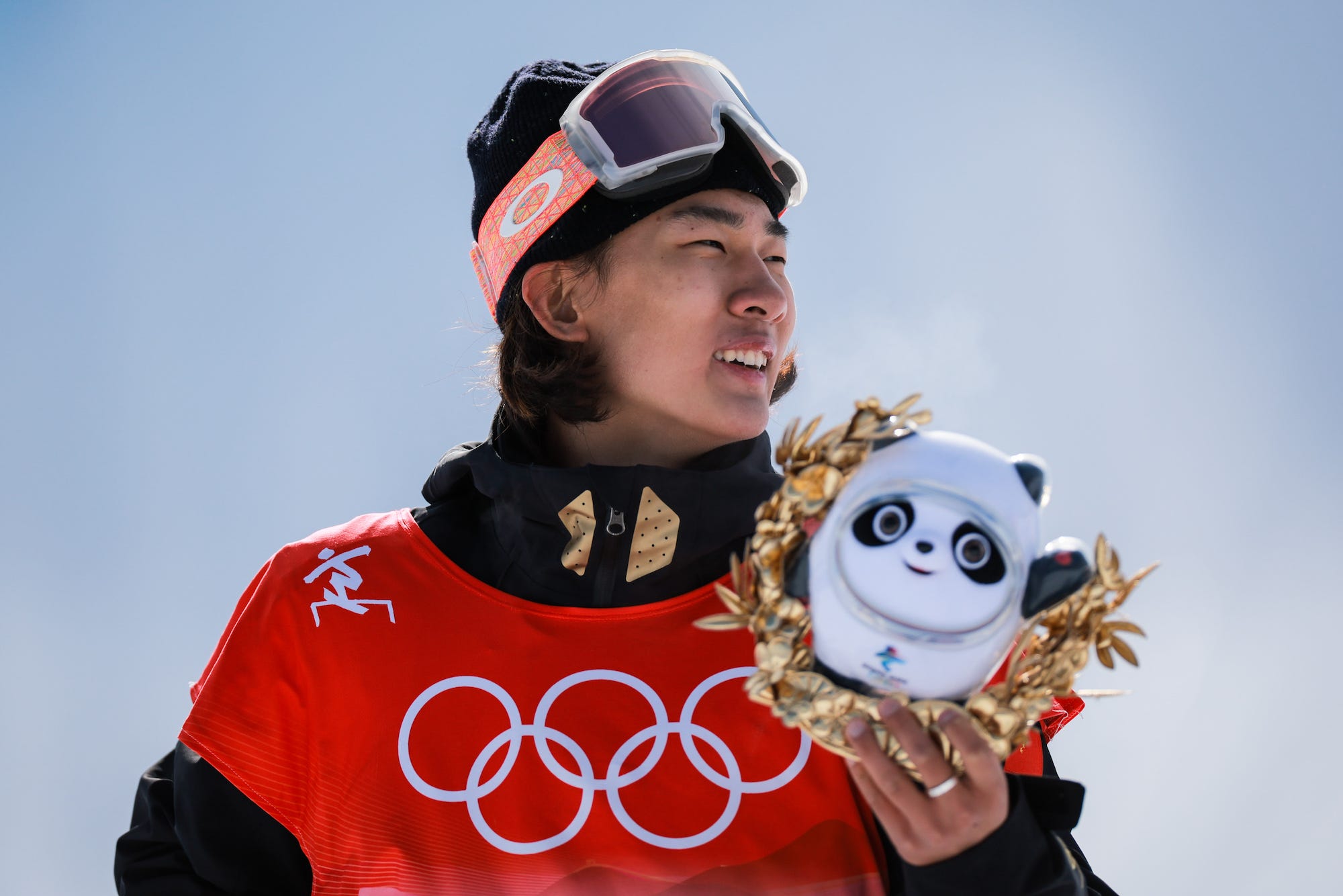 Silver medallist Su Yiming of Team China celebrates after the Men's Snowboard Slopestyle flower ceremony at Genting Snow Park