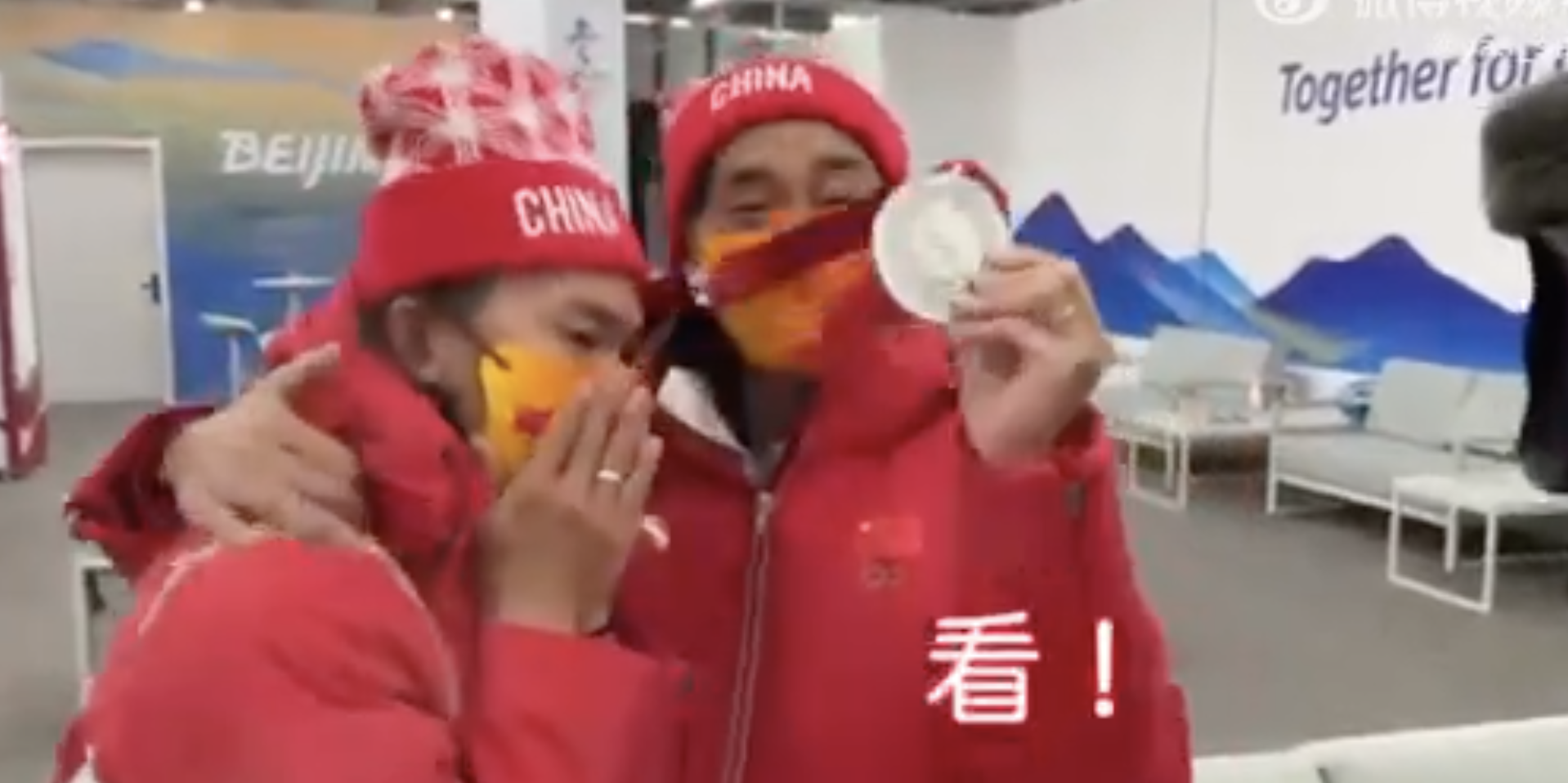 Su Yiming and his coach celebrate winning a silver medal in the men's slopestyle event at the Beijing Winter Olympics.
