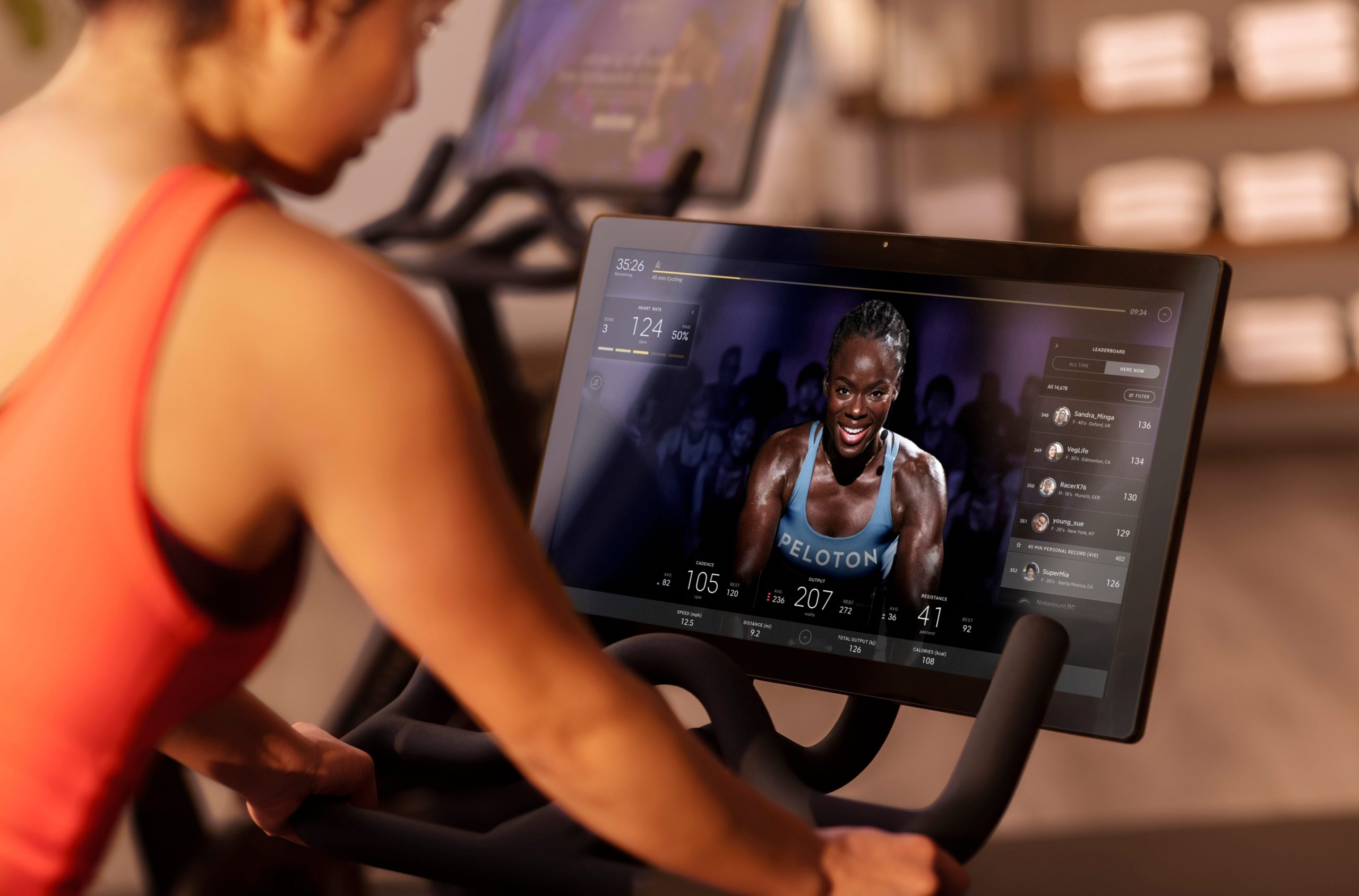 A user watching an instructor on a Peloton bike.