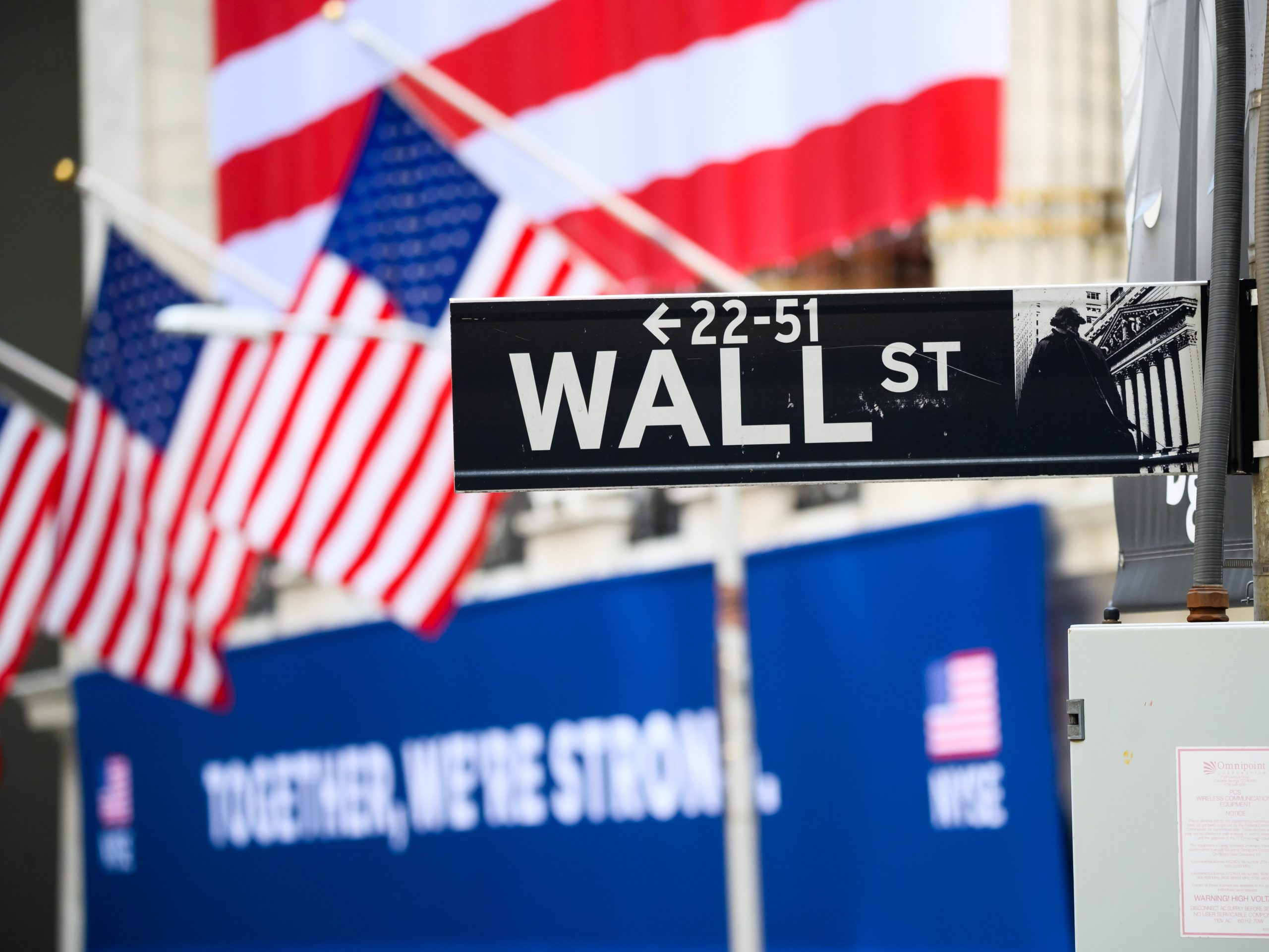 A view of the Wall Street street sign with the New York Stock Exchange during the coronavirus pandemic on May 25, 2020 in New York City.