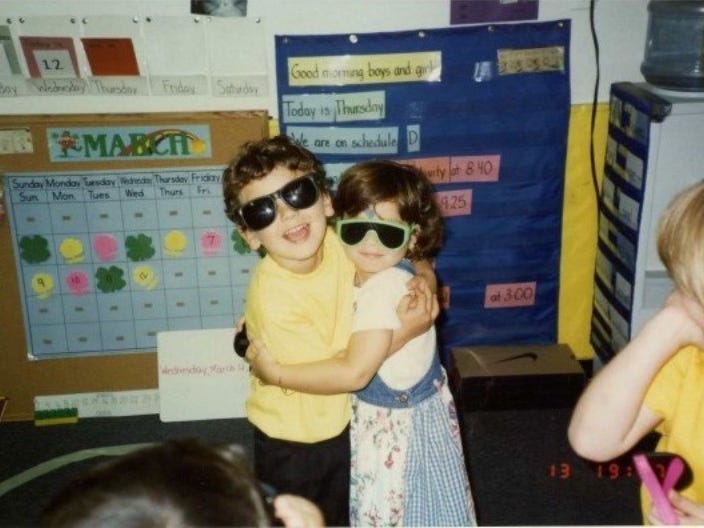 two children hugging in a classroom