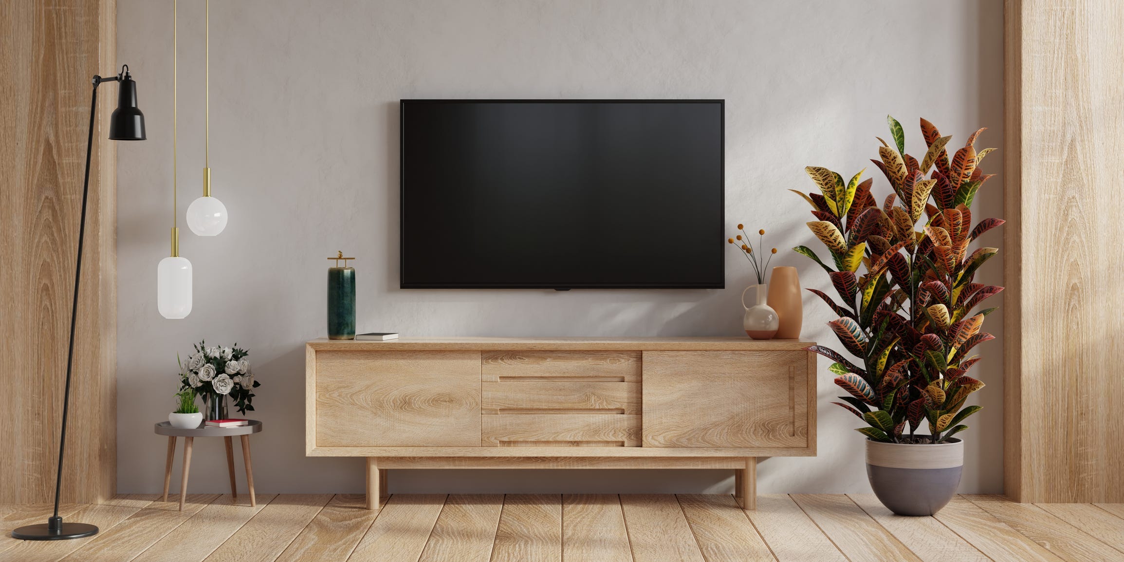 TV on a wall in a warm toned, mid century inspired room