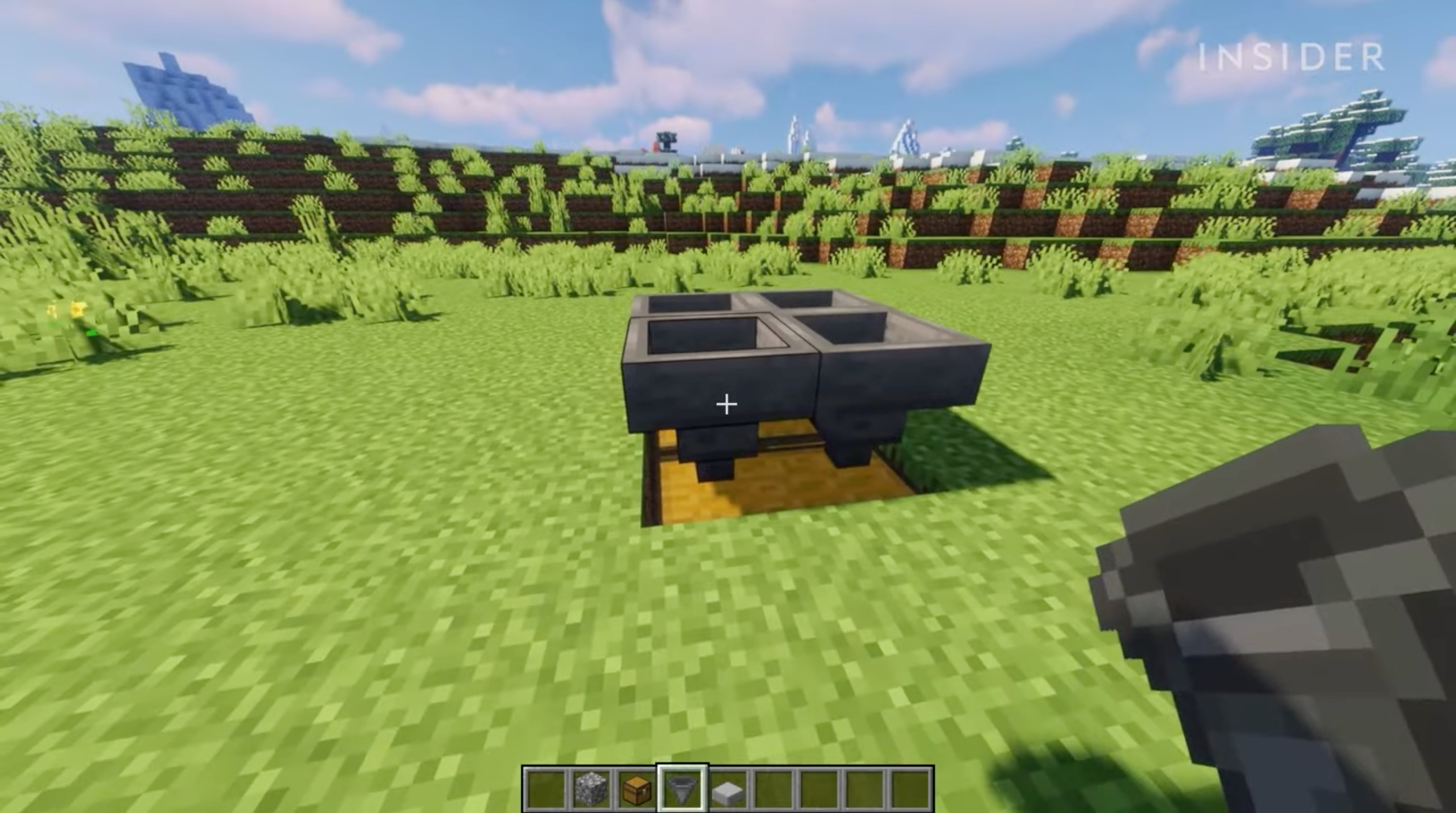 A screenshot from Minecraft, showing a hole filled with treasure chests, and hoppers on top of the chests.