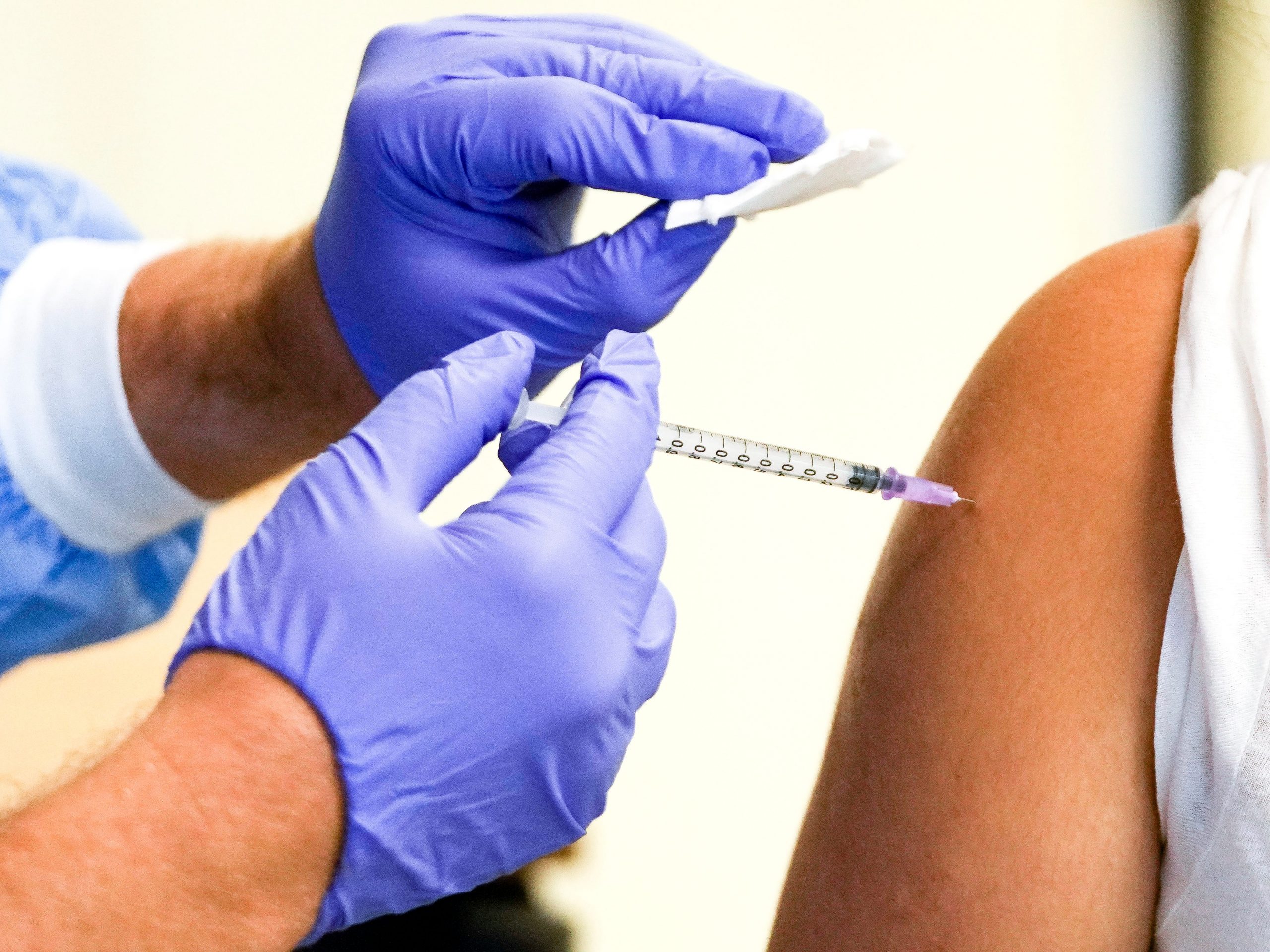 Doctors gives a person a COVID-19 vaccine shot.