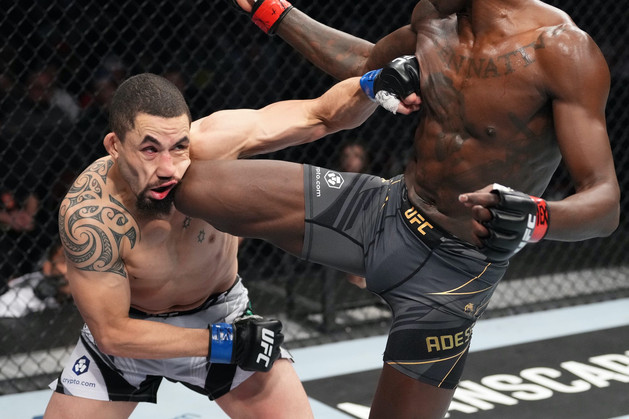 Robert Whittaker's face gets rearranged from an Israel Adesanya knee strike at UFC 271.