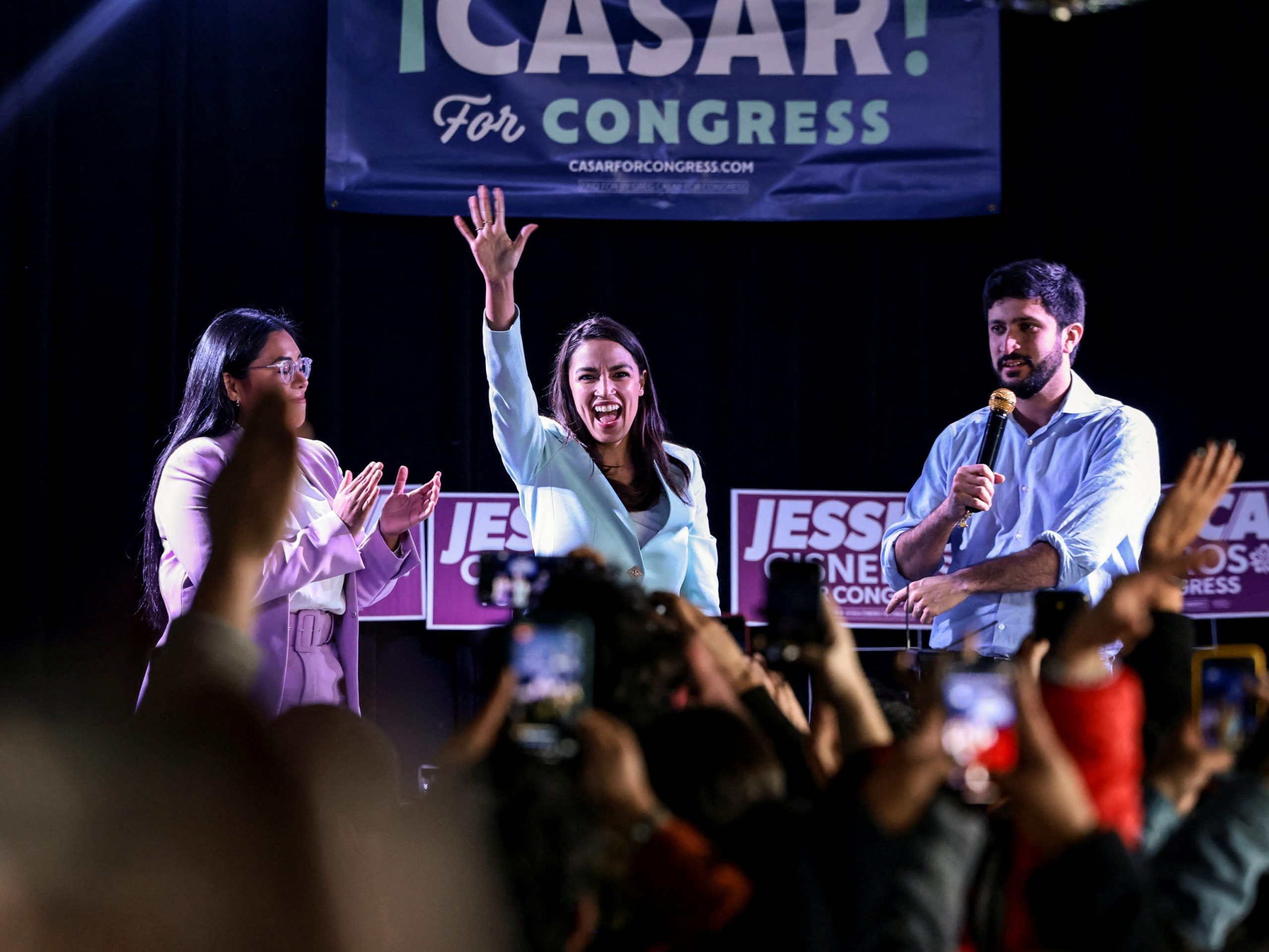 Rep. Alexandria Ocasio-Cortez (center) on stage at a rally in San Antonio, Texas, with progressive Democratic candidates Greg Casar (right) and Jessica Cisneros (left).