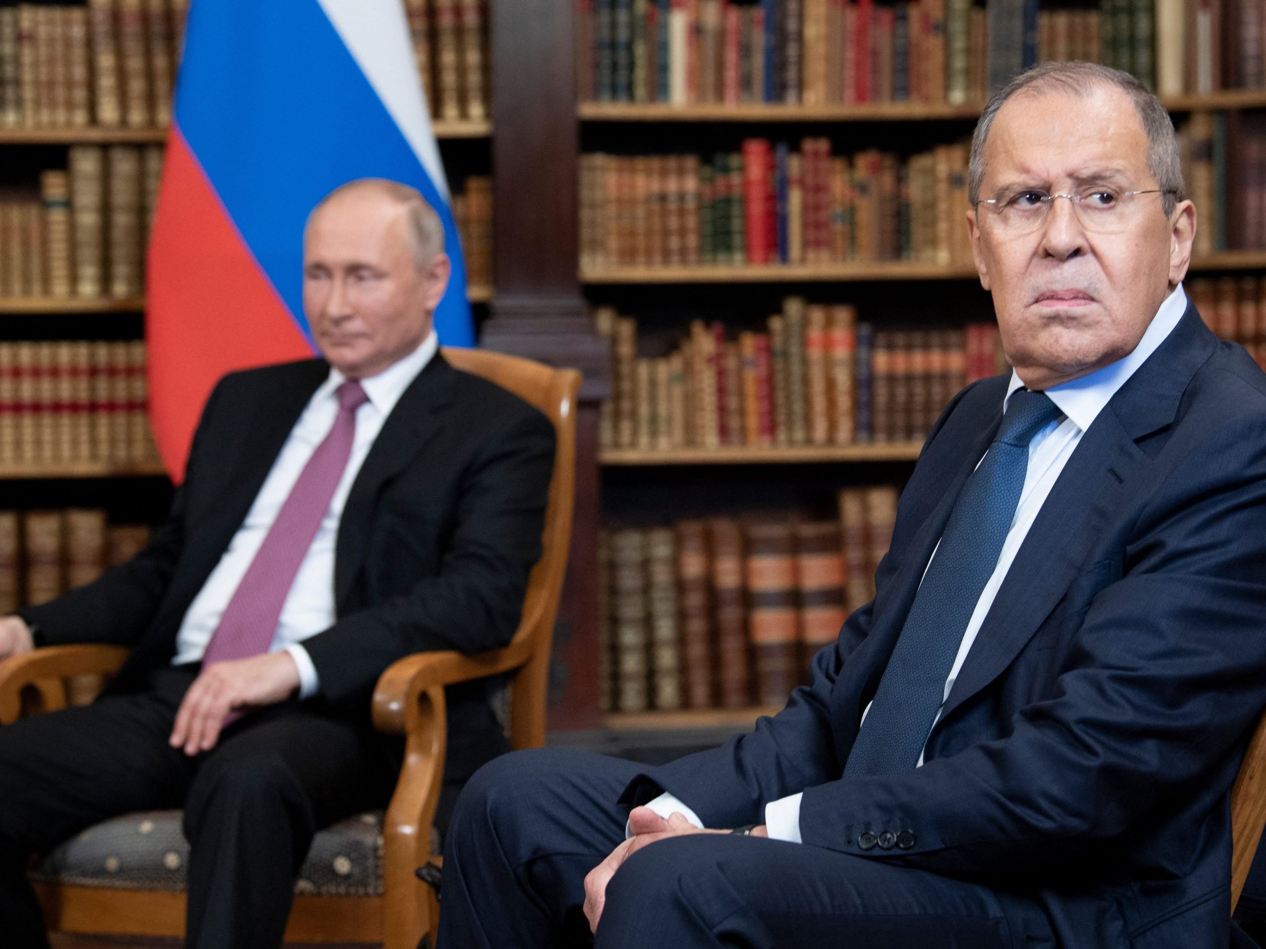 Russian Foreign Minister Sergei Lavrov looks on, next to Russian President Vladimir Putin, as they wait for the US-Russia summit at the Villa La Grange, in Geneva on June 16, 2021.