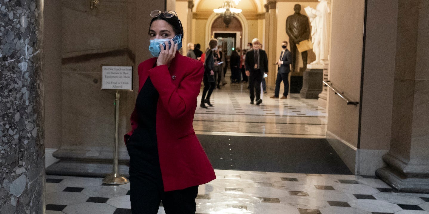 Rep. Alexandria Ocasio-Cortez, D-N.Y., talks on her phone on Capitol Hill, Thursday, Nov. 4, 2021, in Washington