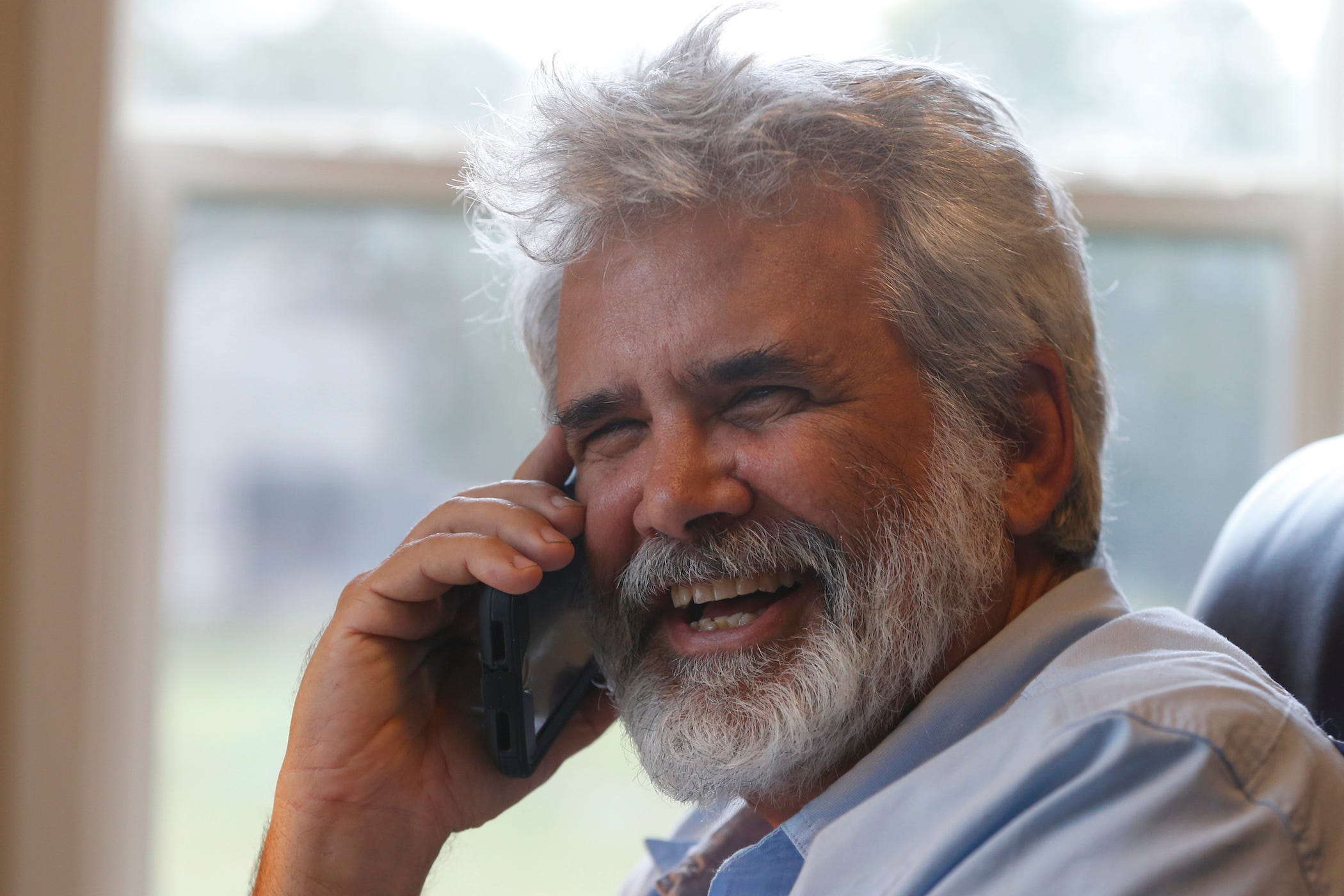dr robert malone on the phone, smiling