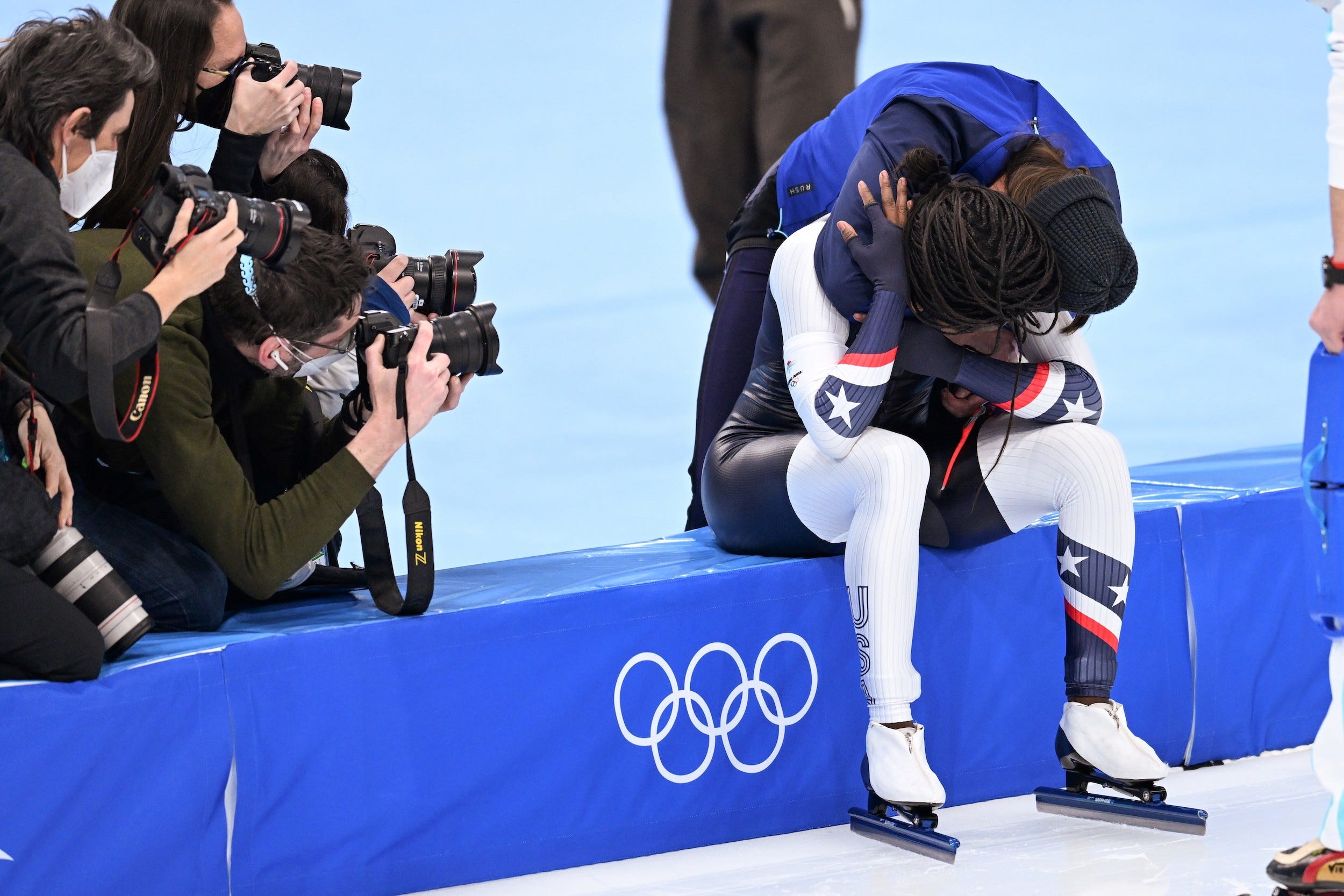 Brittany Bowe hugs Erin Jackson after the latter won her first Olympic gold medal.